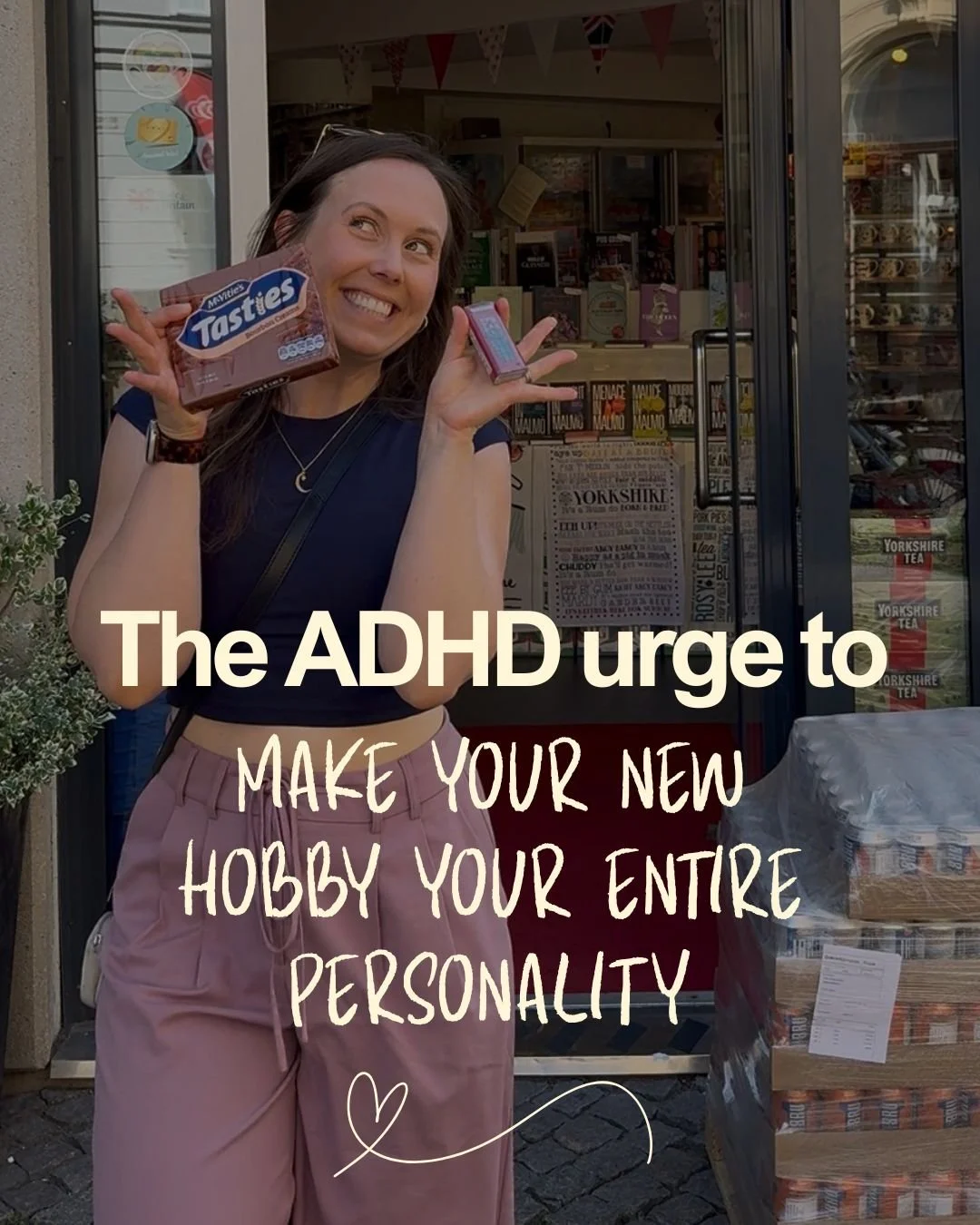 A woman standing outside a store, holding a pack of biscuits, smiling and looking up. The store has a glass door and a display of products inside. Overlaid text reads 'The ADHD urge to make your new hobby your entire personality.'