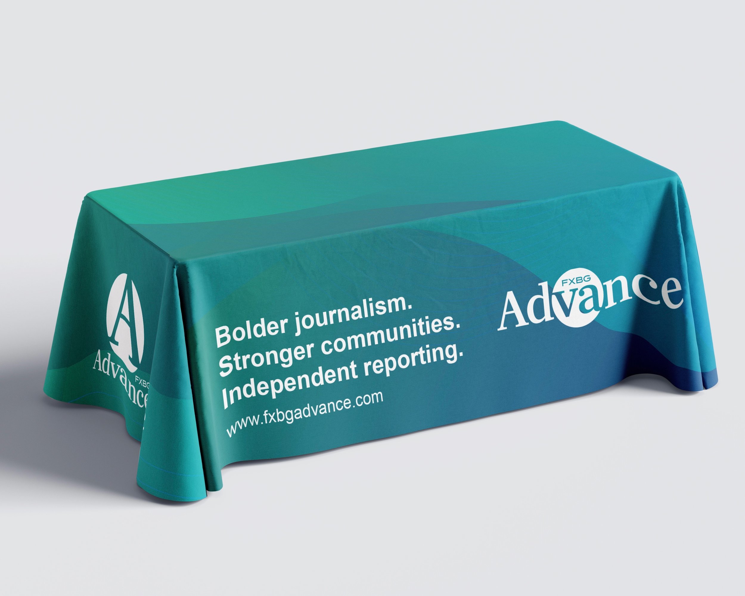 Teal tablecloth with white text and logo promoting independent journalism and community strength, featuring the website www.fxbadvance.com.
