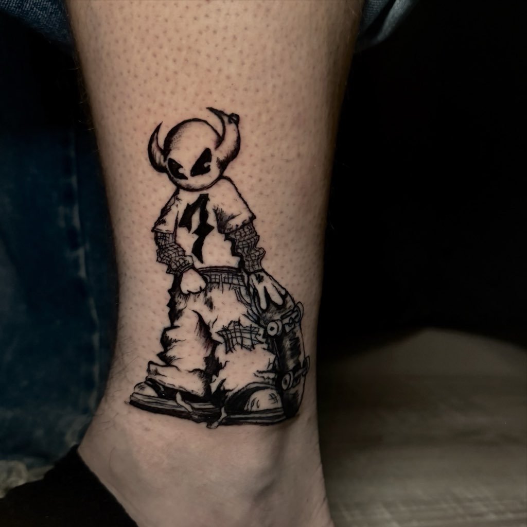 Tattoo of a cool alien with horns in cartoon style.