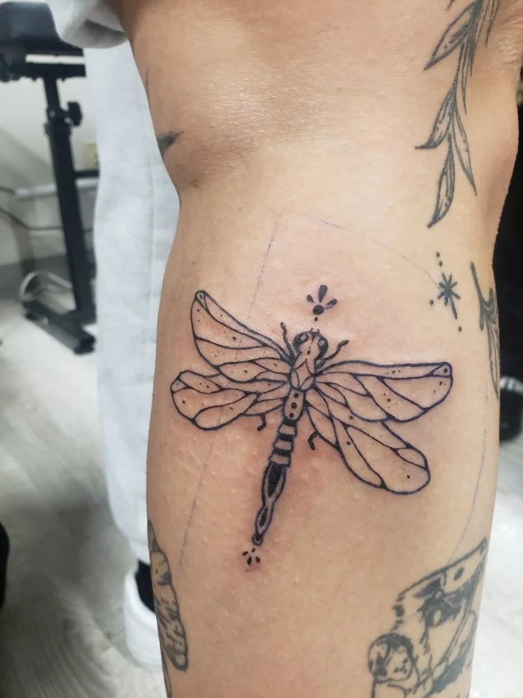 Tattoo of a detailed dragonfly.