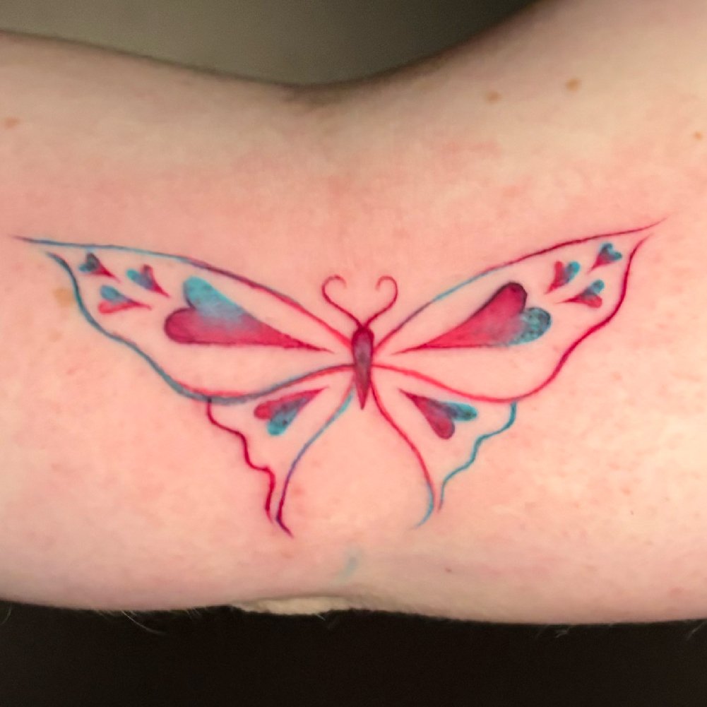Colorful fine line tattoo of a butterfly.