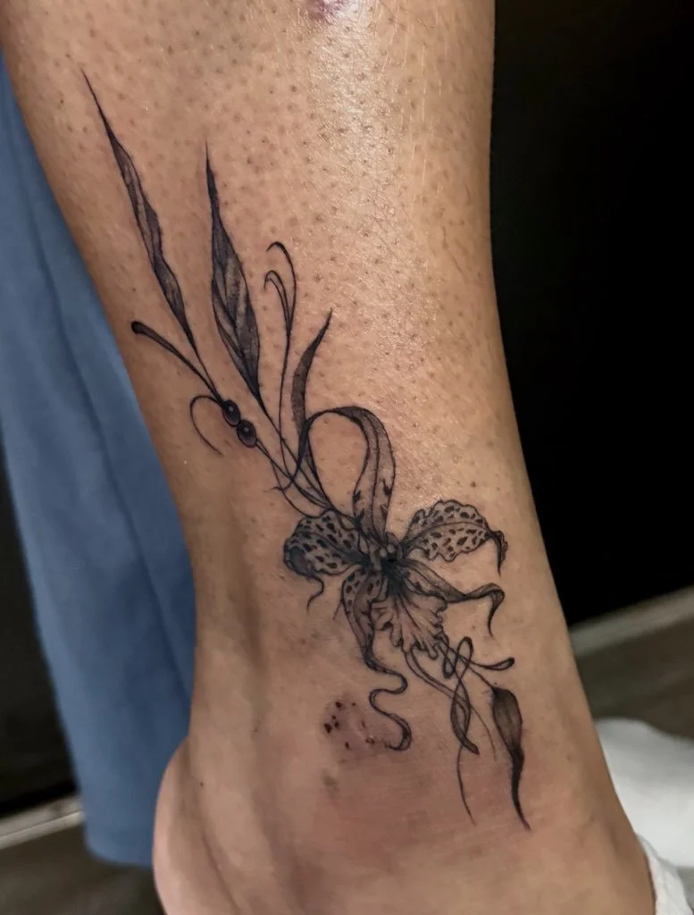 Tattoo of a somewhat abstract tiger lily.