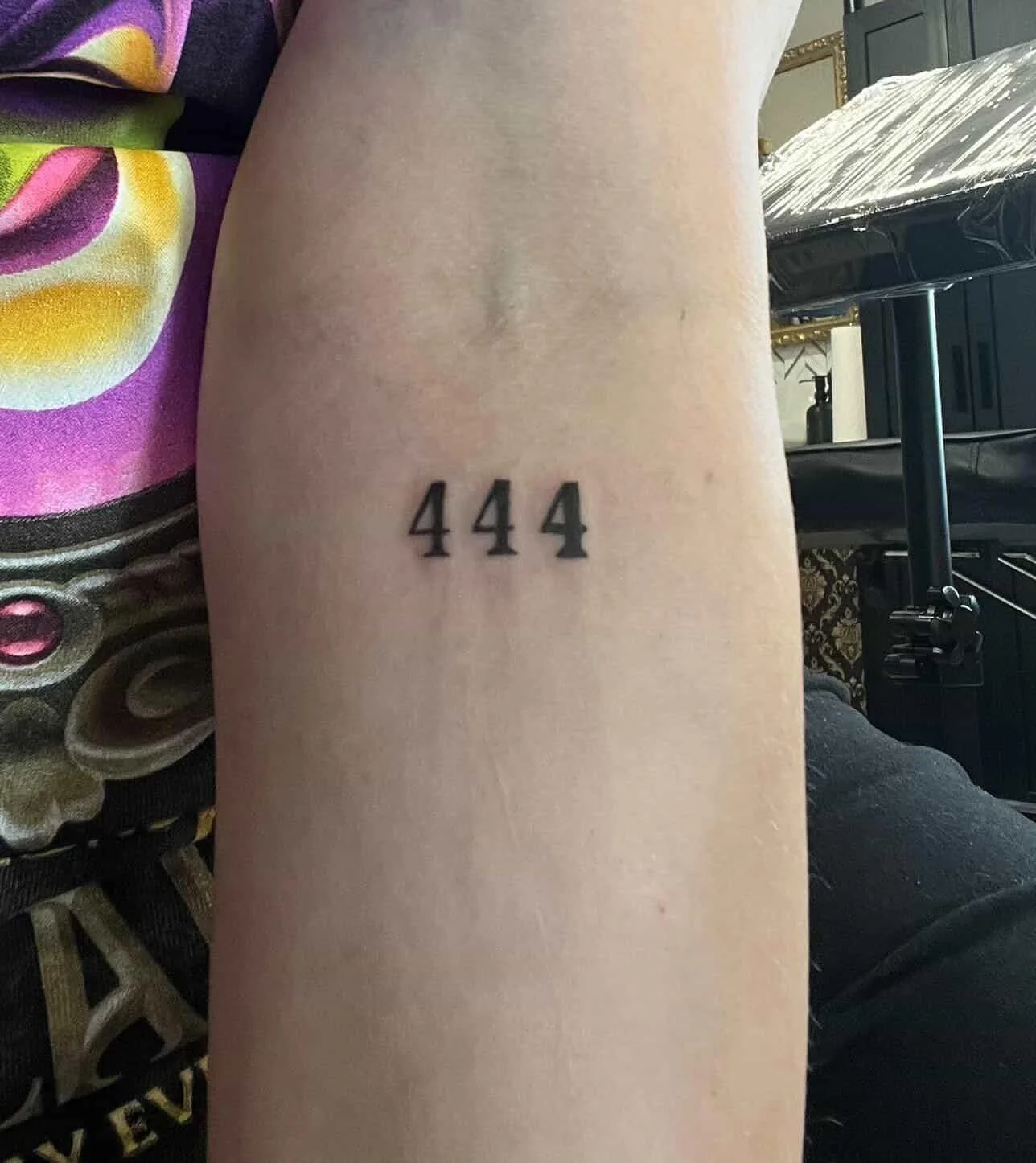 San serif font tattoo of the numbers 444.