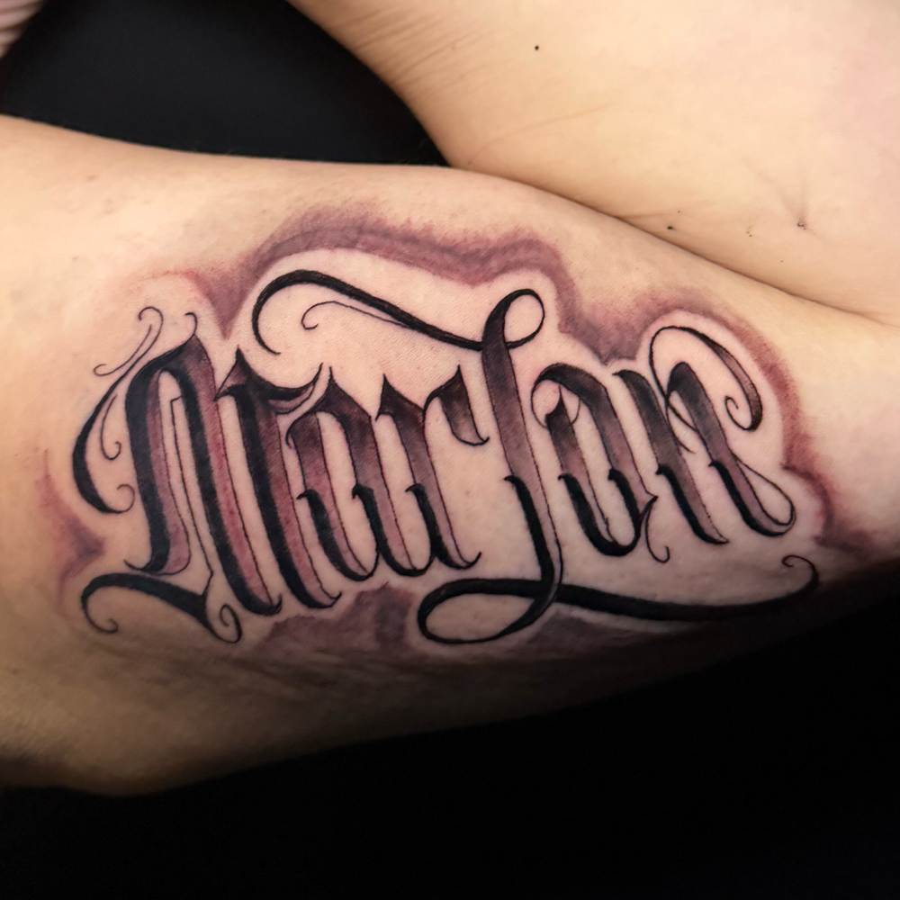 Cursive text of a family name.