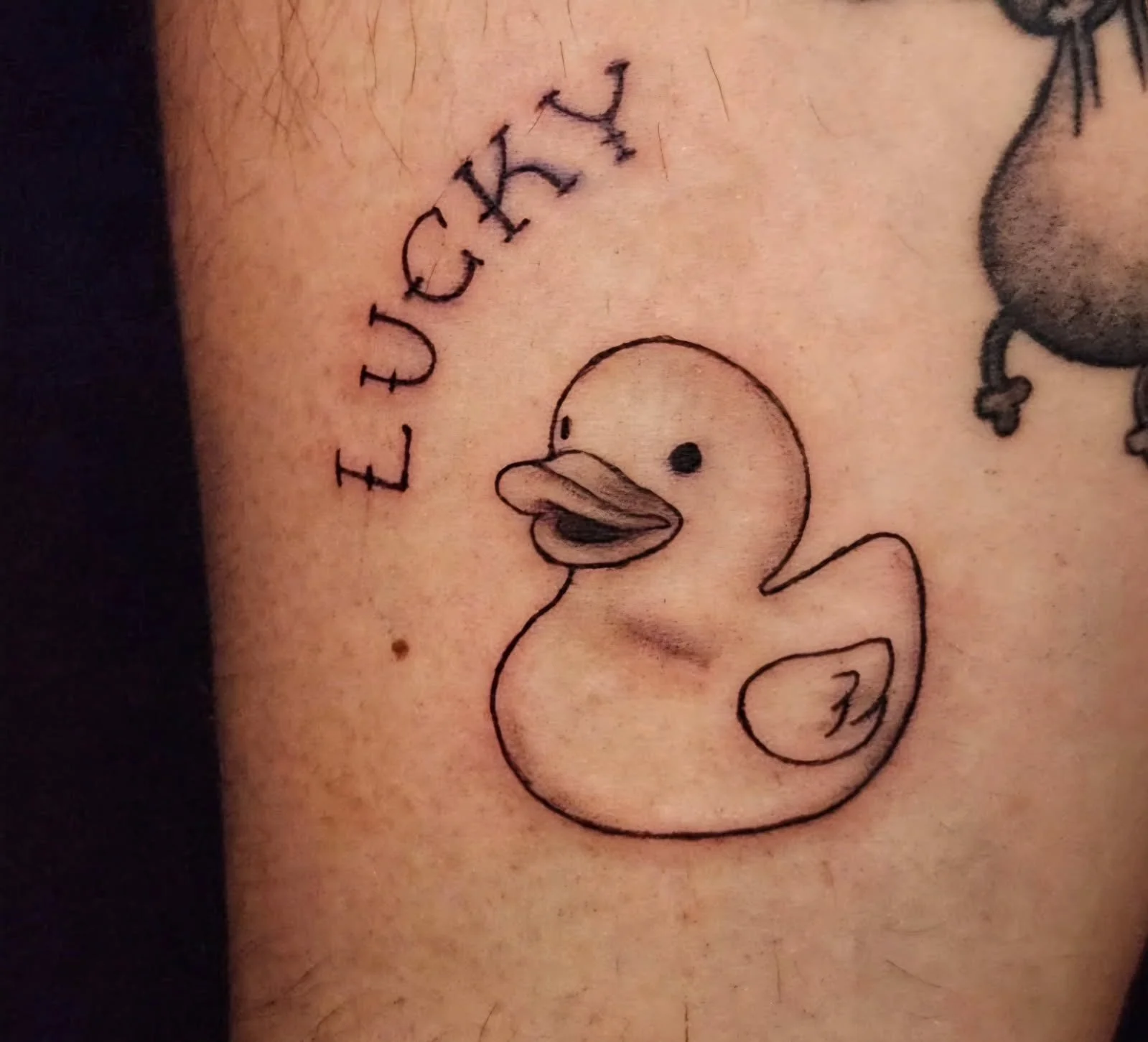 Fine line Lucky Duck tattoo.