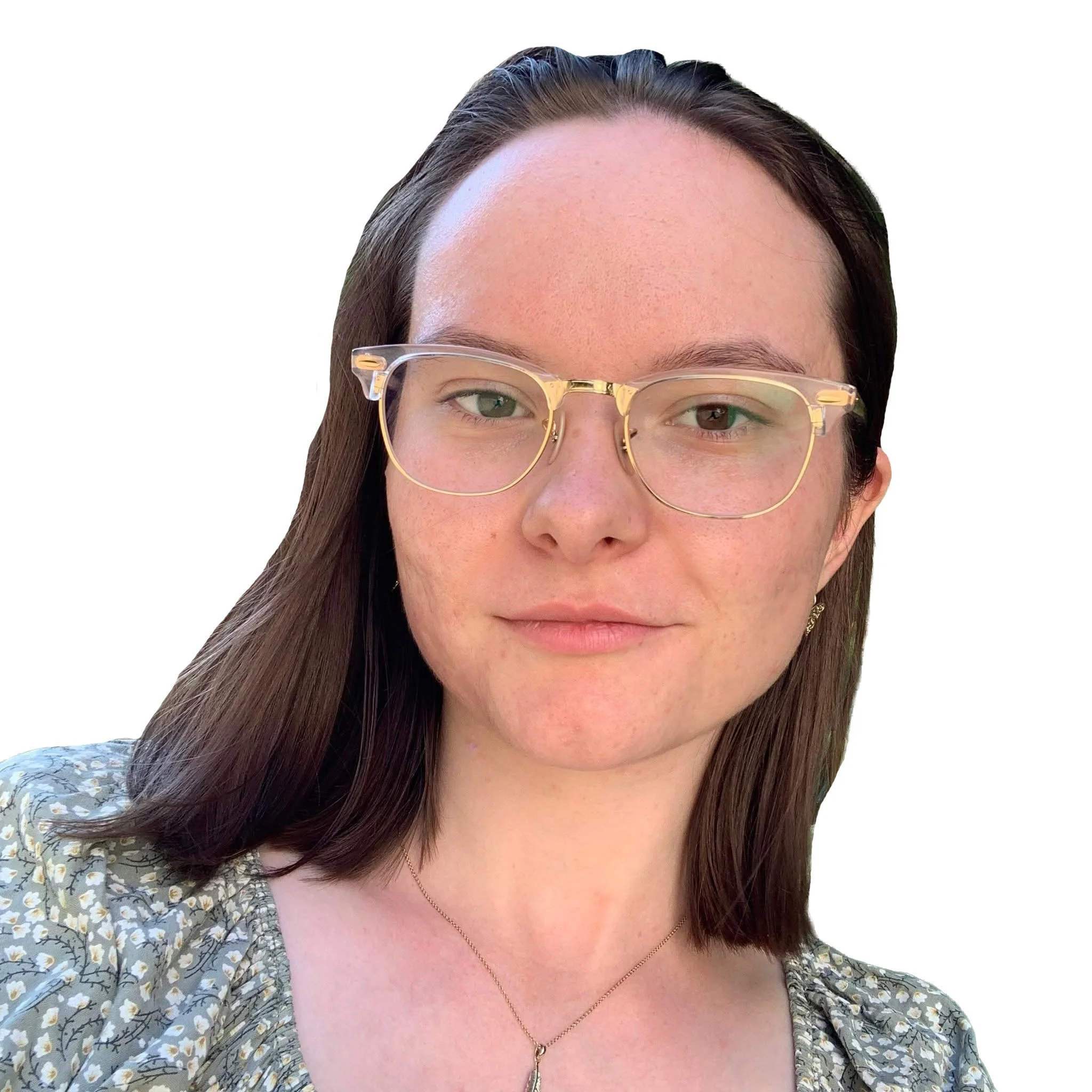 Portrait photo of Devon Eustace with shoulder-length brown hair wearing gold-rimmed glasses and a floral patterned top with a delicate necklace, photographed against a white background.