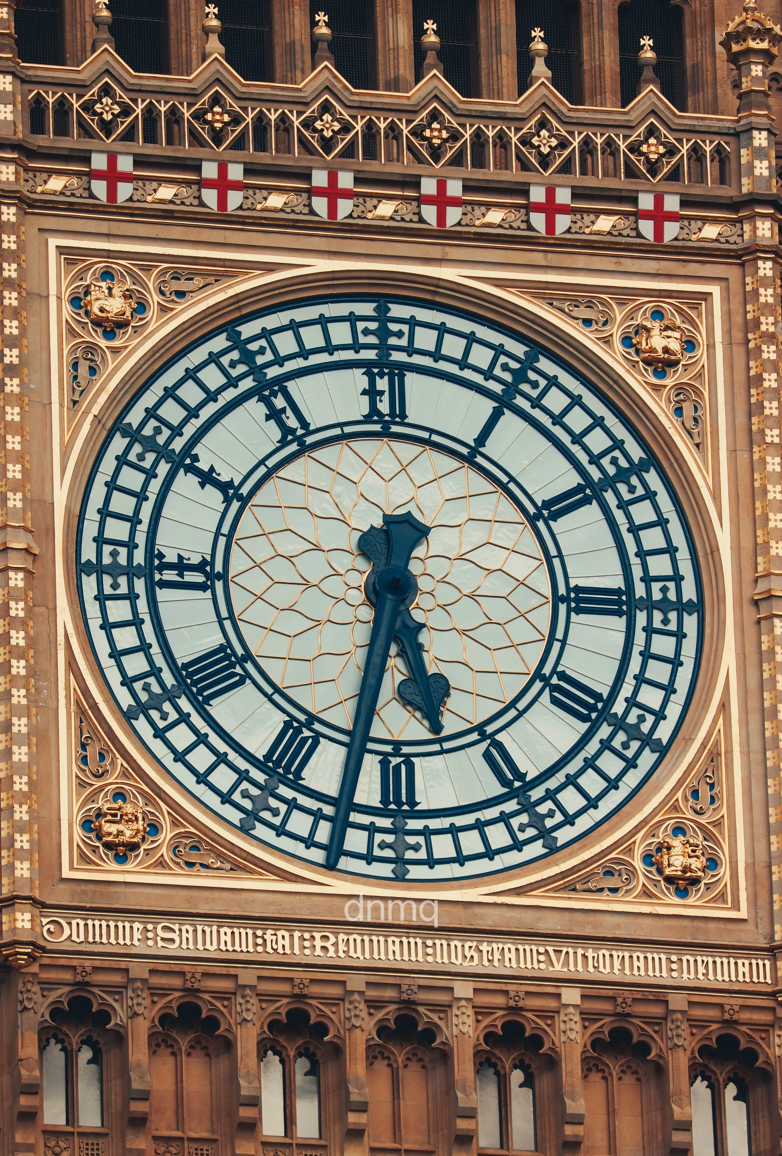 Clock tower with Roman numerals and ornate decorative details at the top.