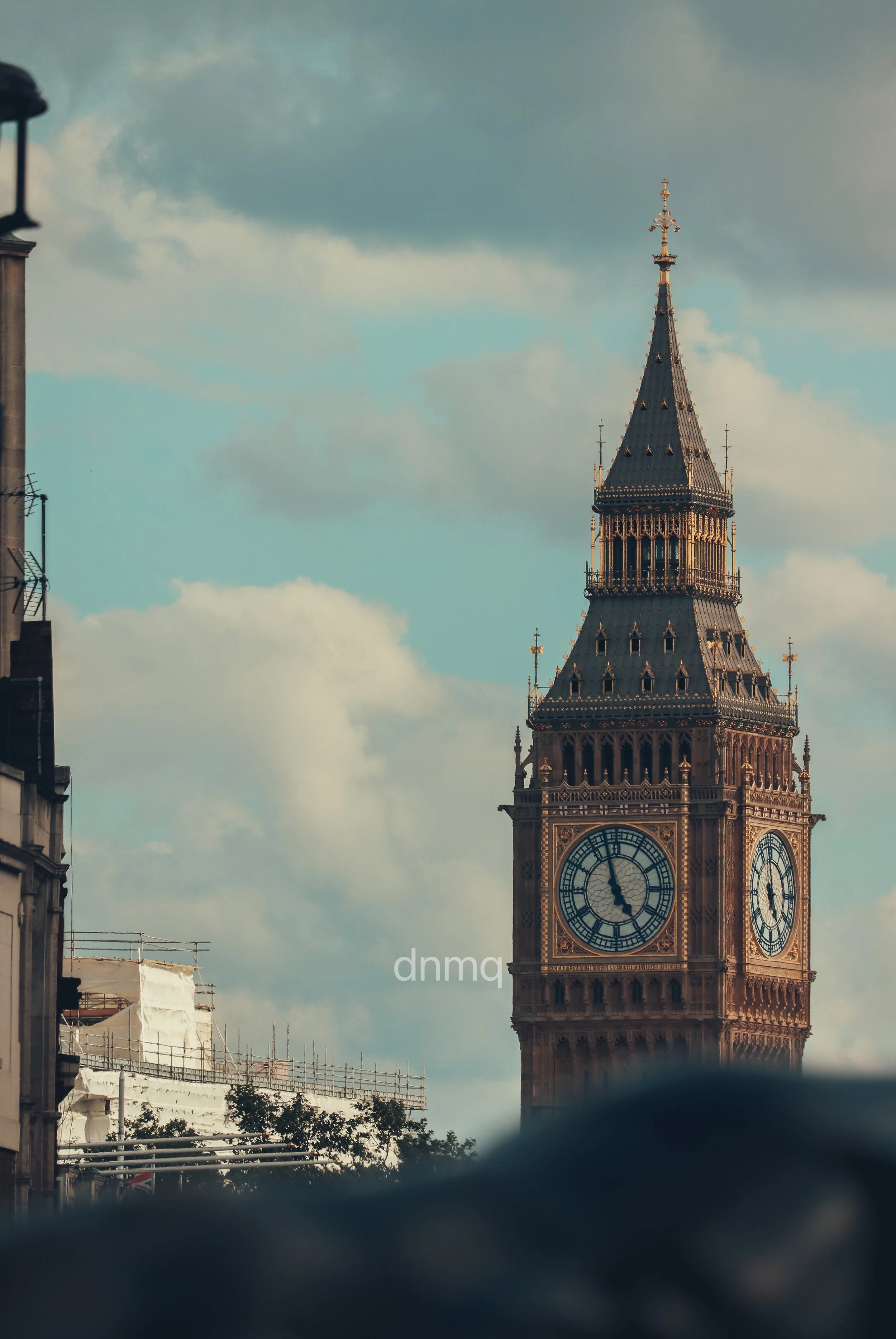 Big Ben clock tower in London with a cloudy sky in the background.