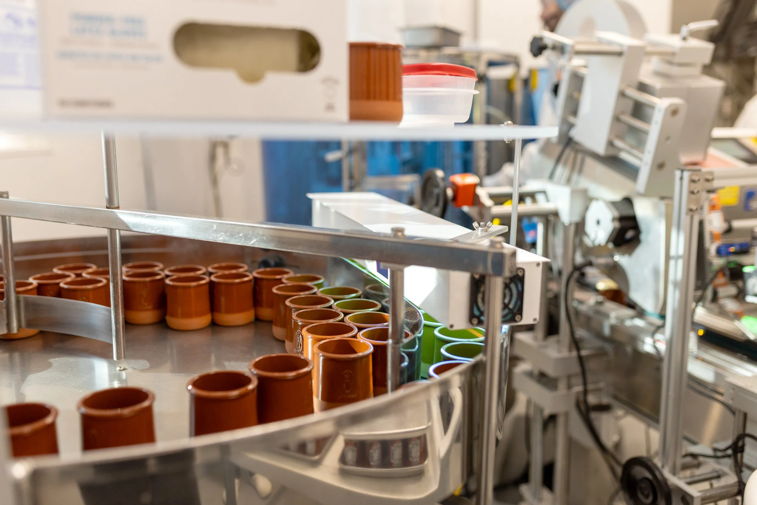 Laboratory setting with test tubes on metal racks and scientific equipment in the background.