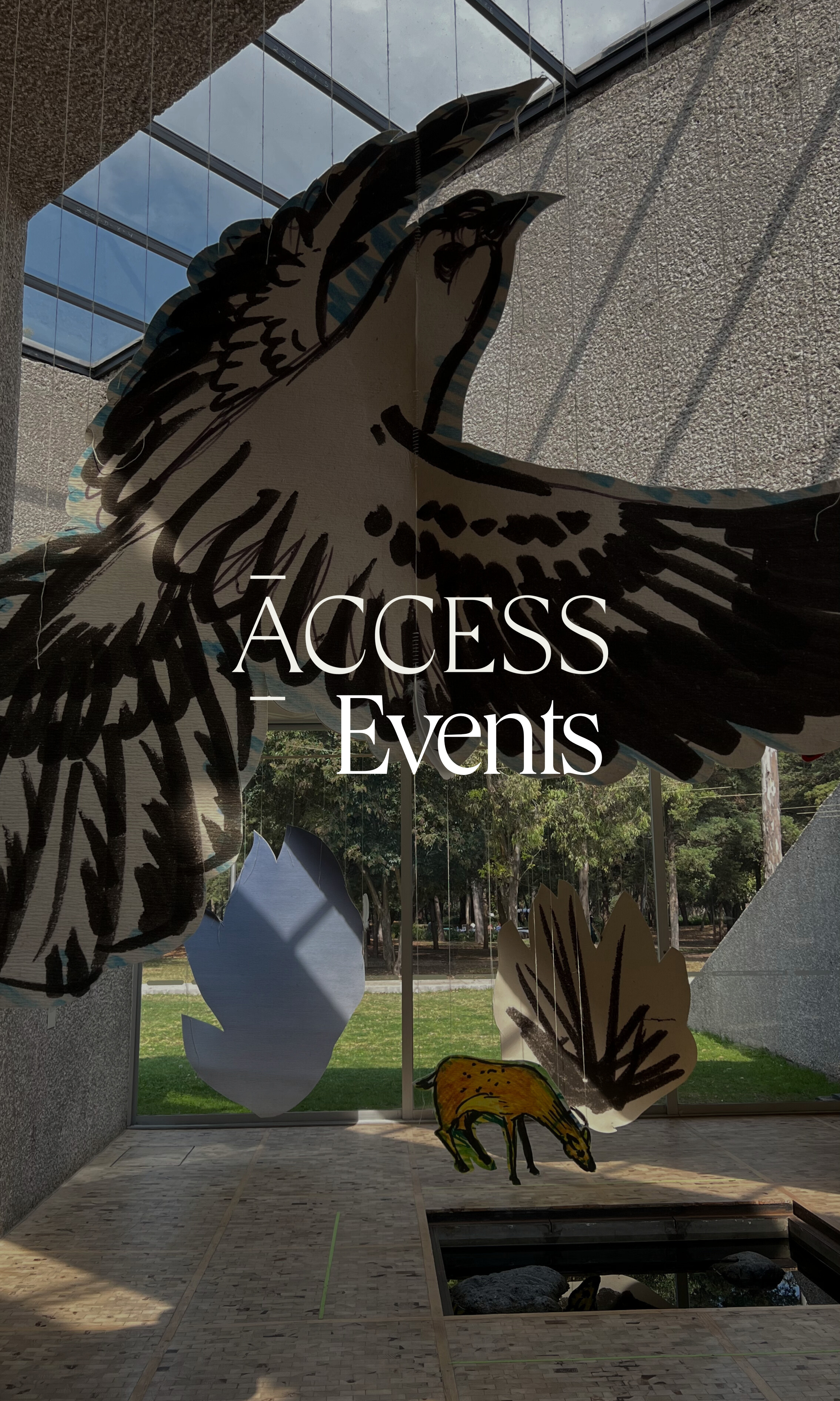 A decorative window display with an illustration of an eagle with outstretched wings and feathers, and the words "Access Events" in white text across the center. Outside view of trees and grass through the window.