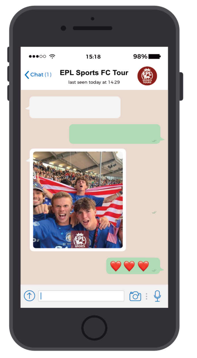 A WhatsApp chat window featuring a photo of four young men celebrating at a sports event, holding an American flag, with a crowd in the background. The chat has a message with three red hearts.