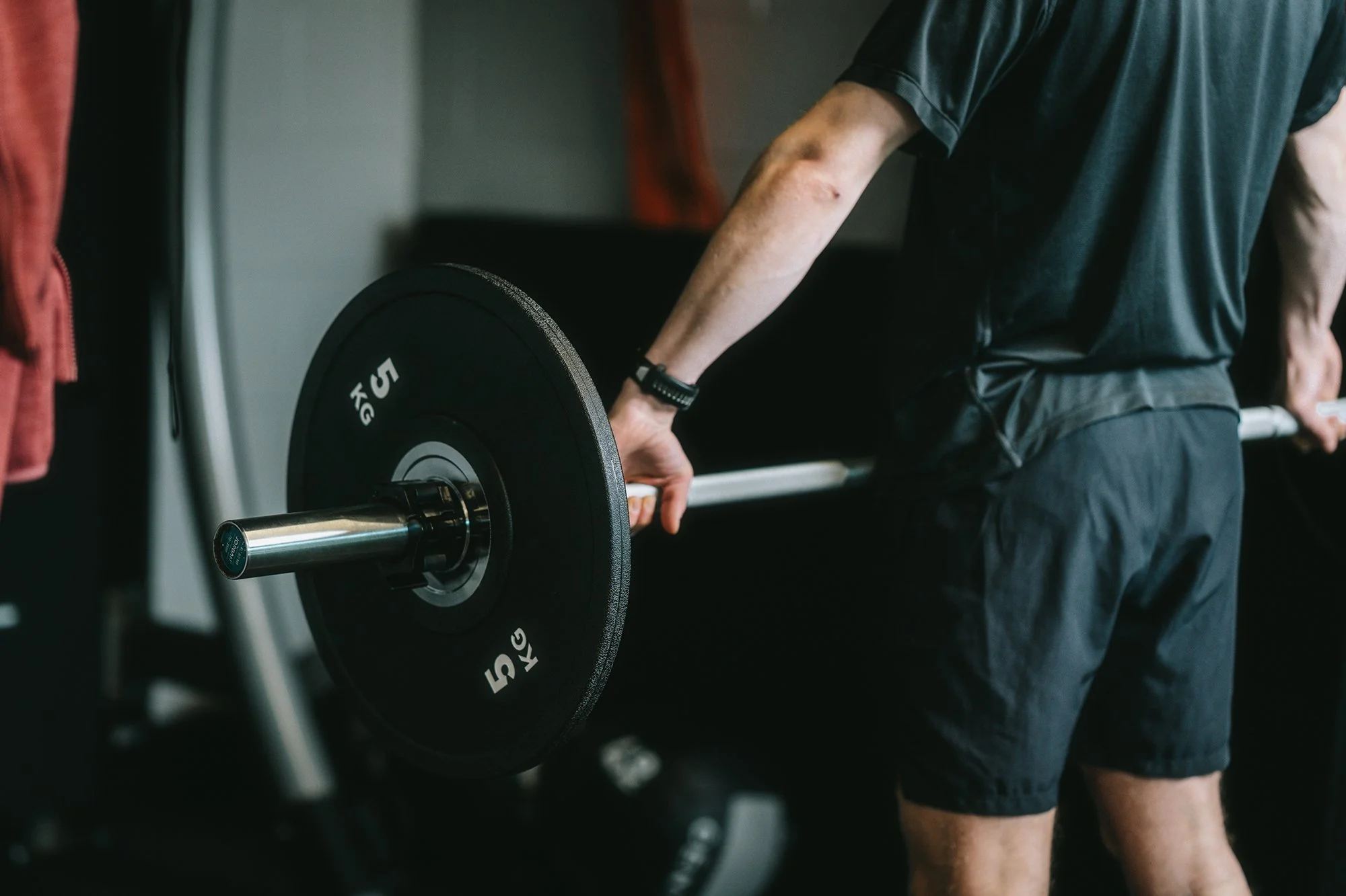 Person performing a deadlift in a gym.