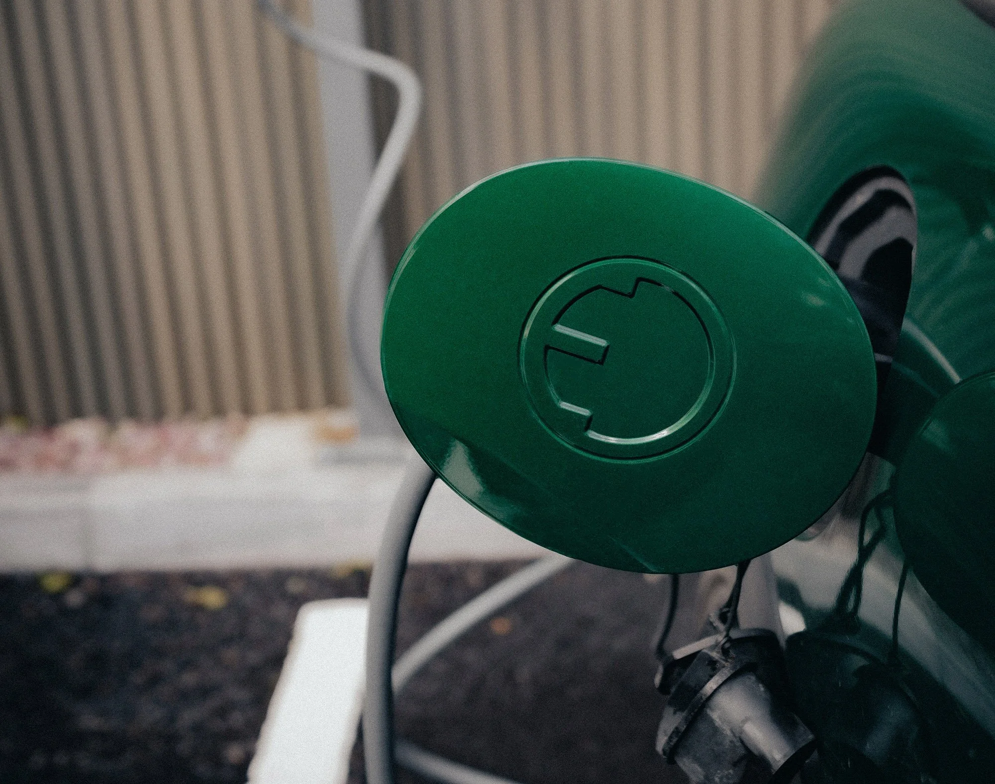 Close-up of a EV charging cable plugged into a cars charging port.