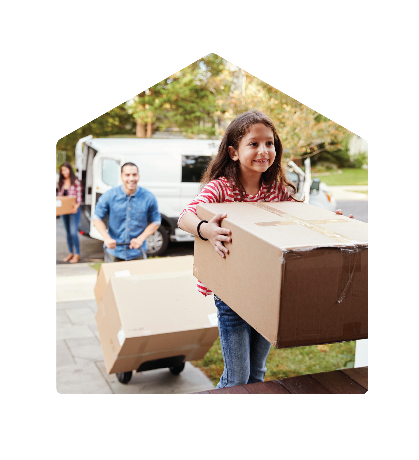 Young girl carrying a brown cardboard box into her new home. Her father follows with a box on a dolly.