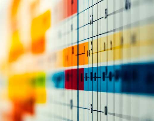 Close-up of a colorful Gantt chart with grid lines and blurred background.