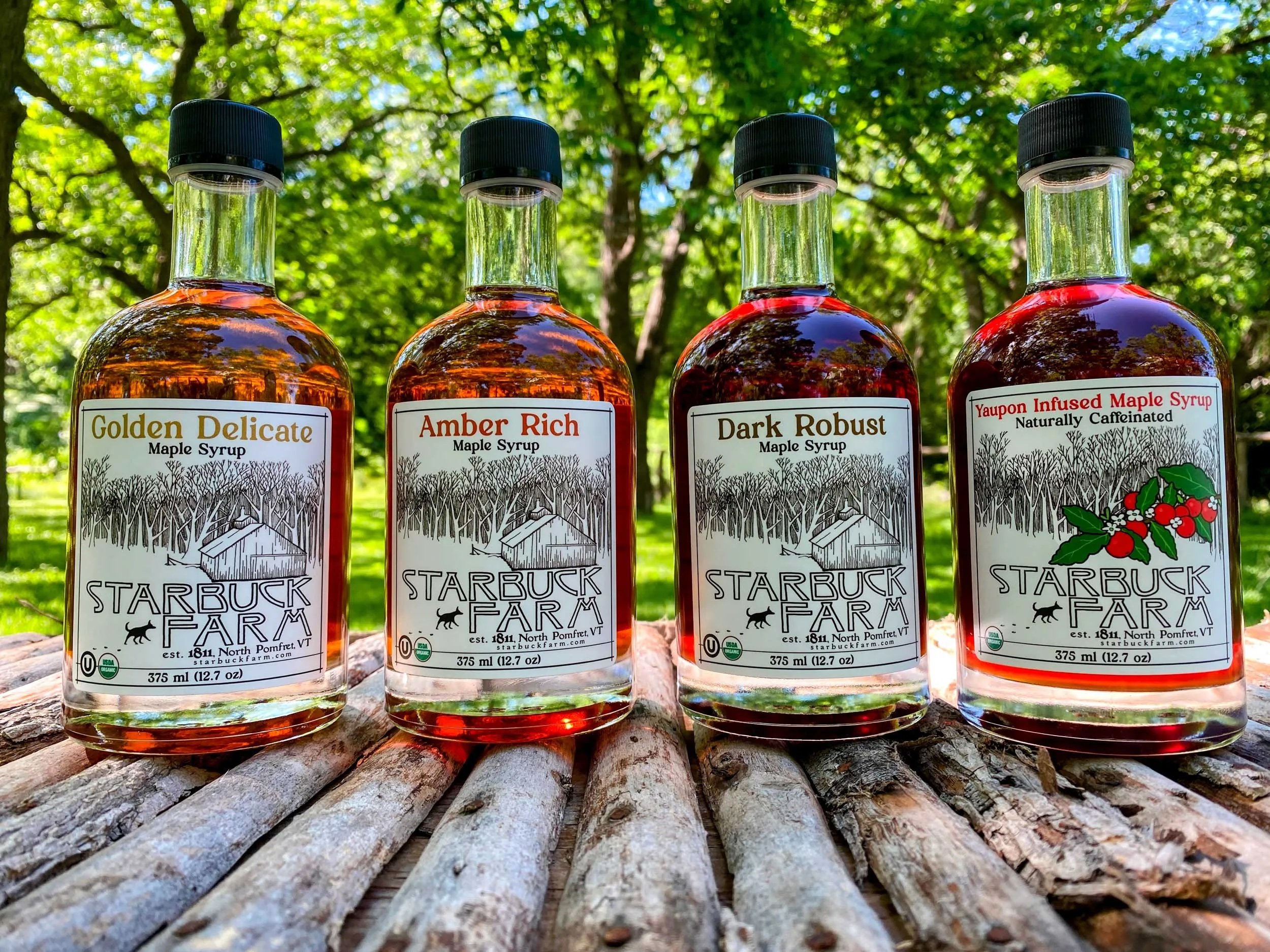 Four bottles of maple syrup on a table
