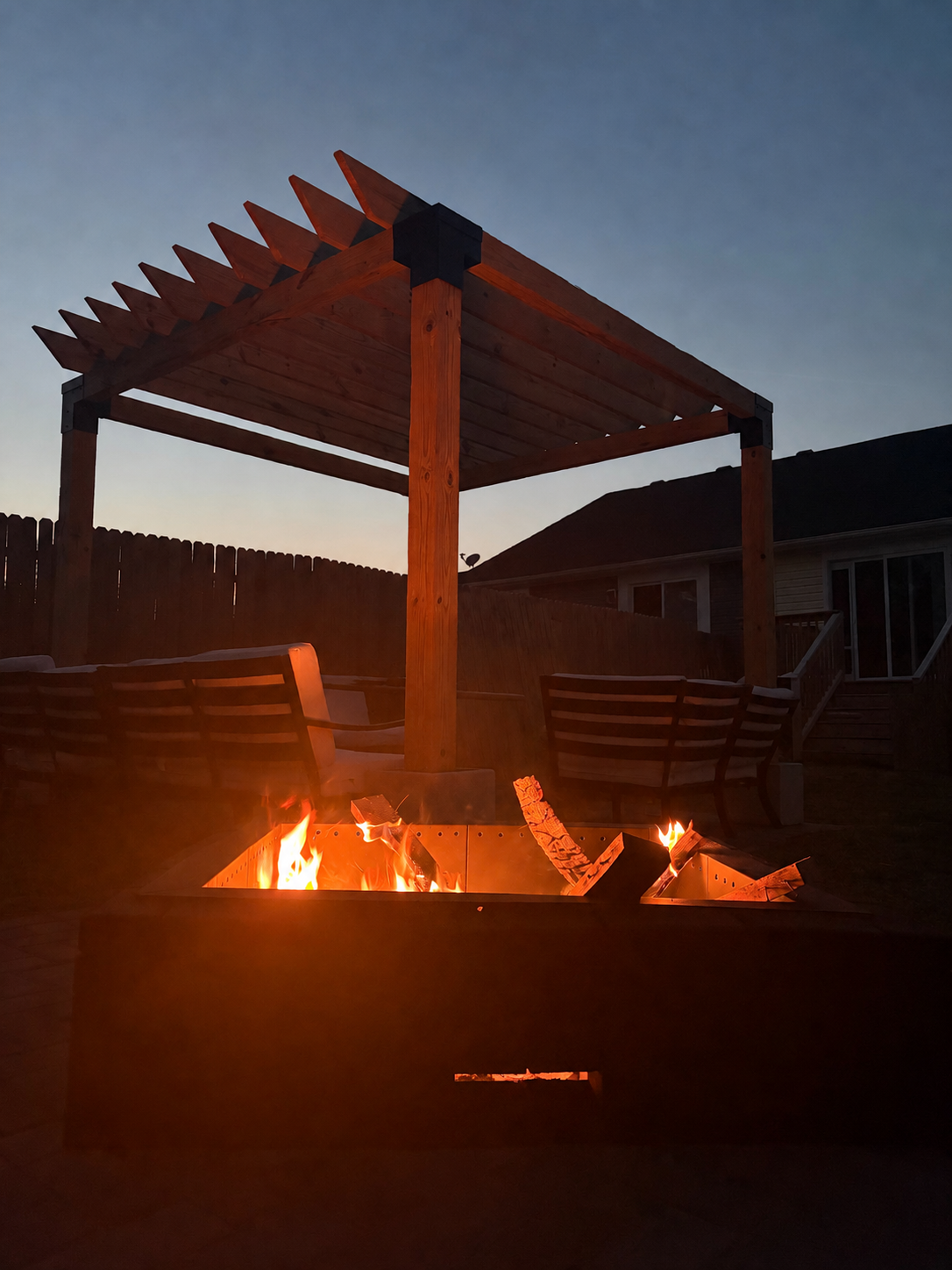 backyard fire pit with custom sized pergola and black, powder-coated steel brackets by Lyoness Industries
