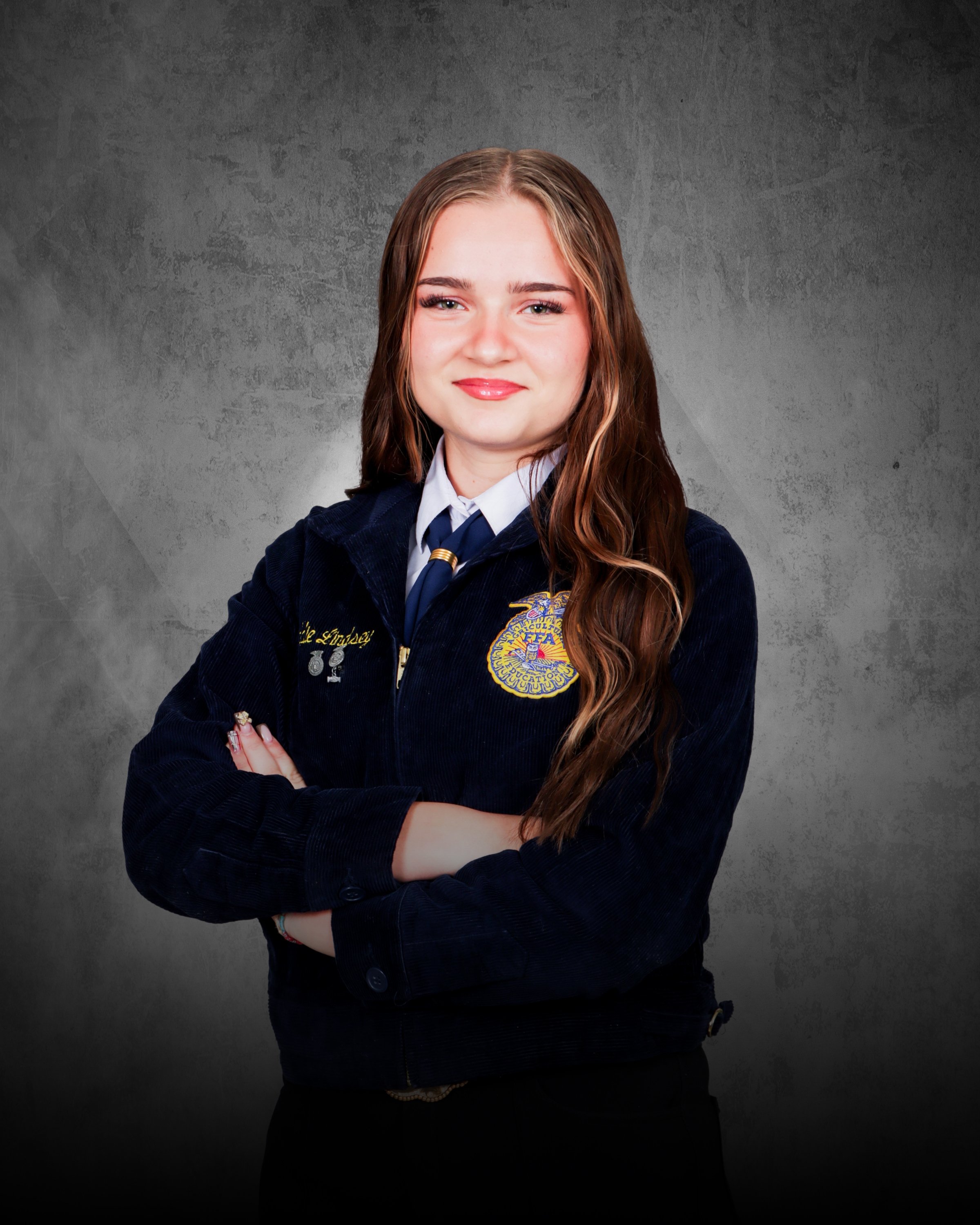 A young woman smiling and holding two white rabbits in front of a garage door.