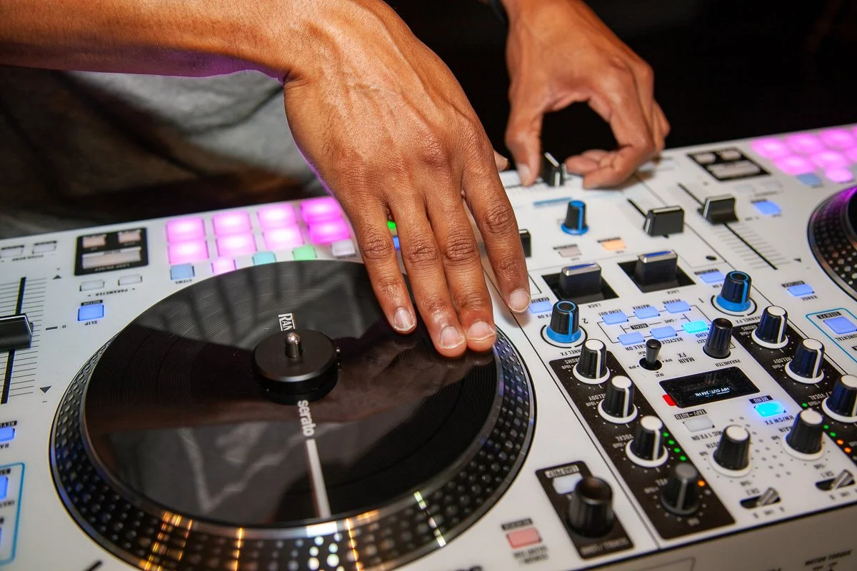 DJ Leggs Using a Rane One MKII controller with their left hand on the turntable and their right hand adjusting controls.