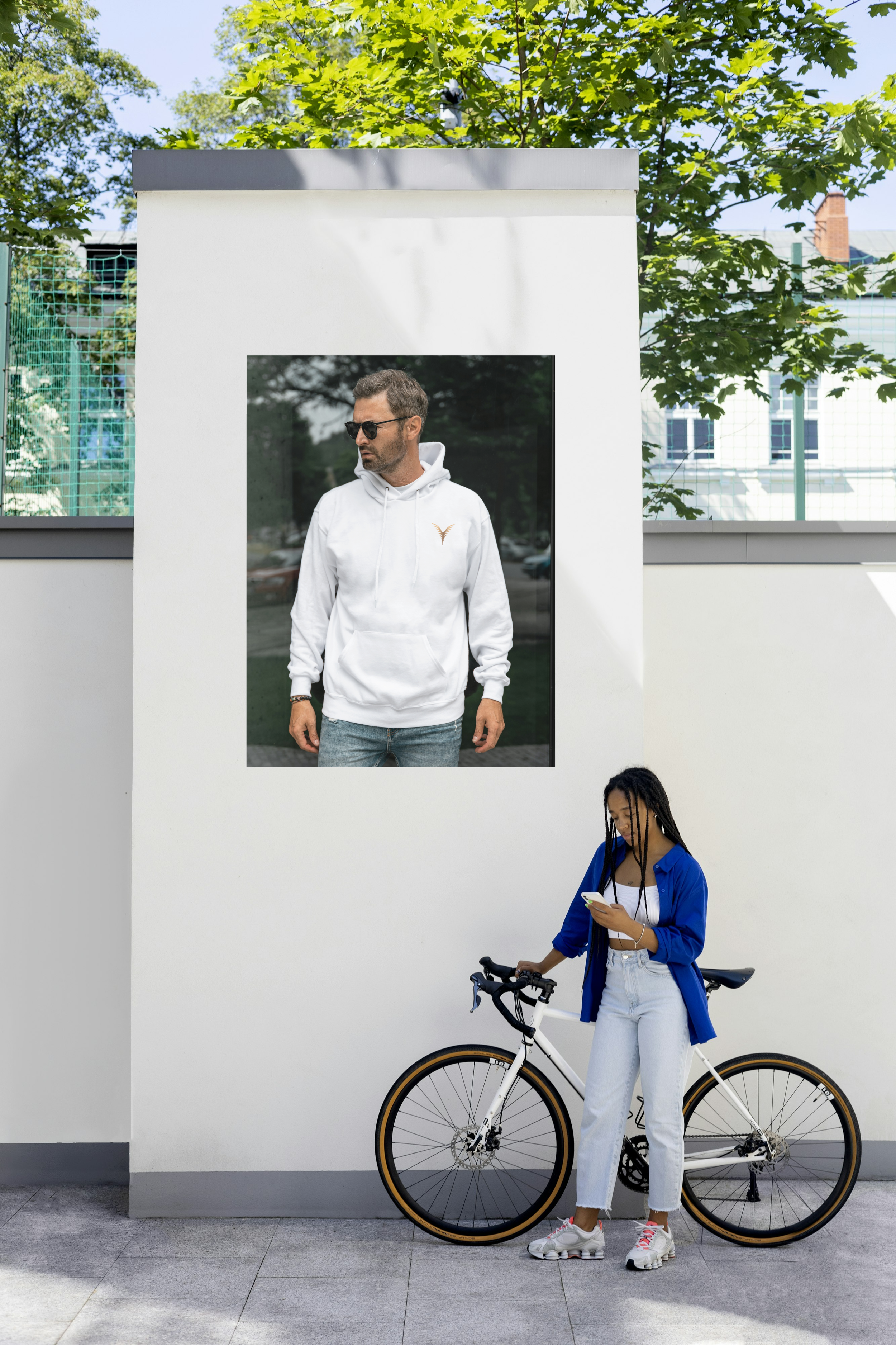 Street poster of a man wearing white "HoodiSquad" from stYle Collections by YXELON.