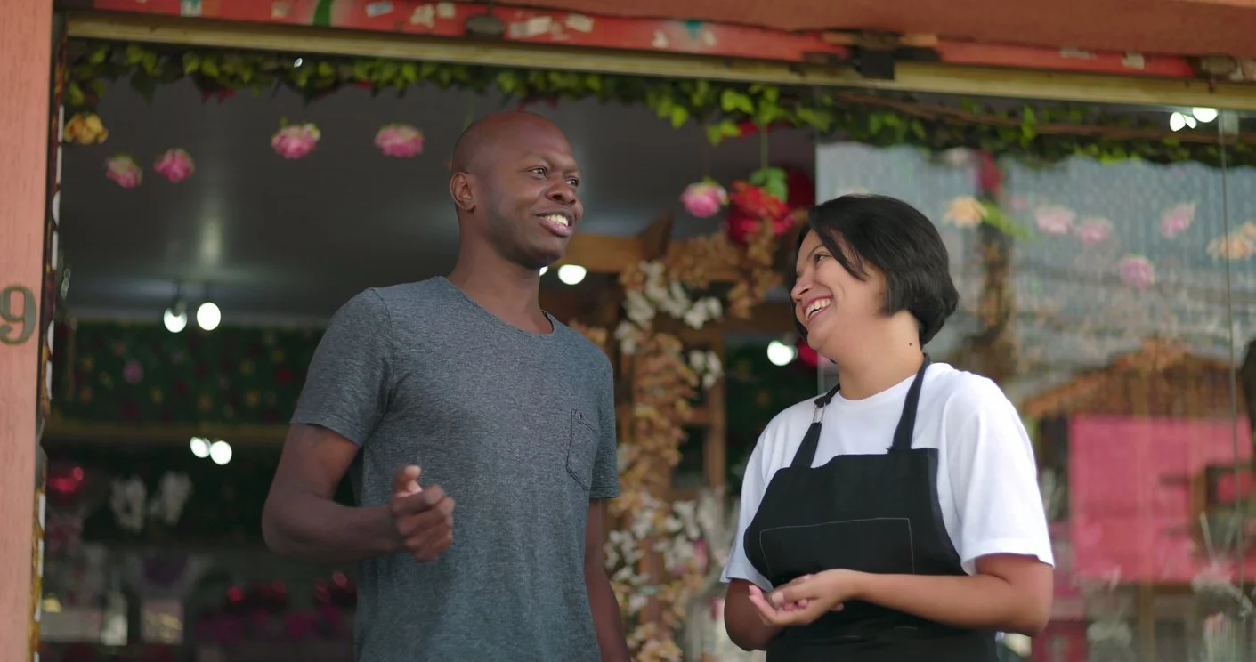 Shop owner and customer talking happily