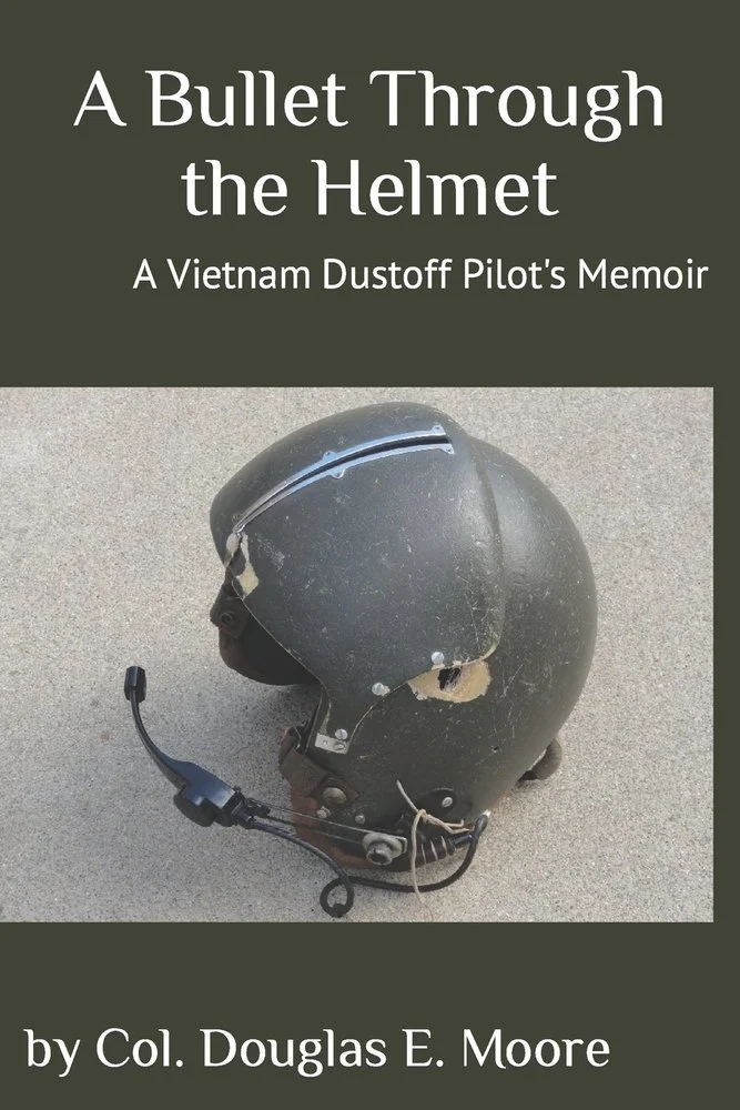 Book cover titled "A Bullet Through the Helmet: A Vietnam Dustoff Pilot's Memoir" featuring a worn military helmet with a damaged surface and attached communication headset, placed on a gray surface.