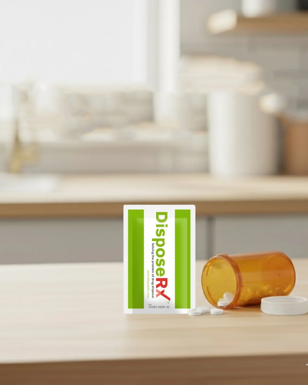 Picture of in-home drug disposal packet next to open medicine vial.