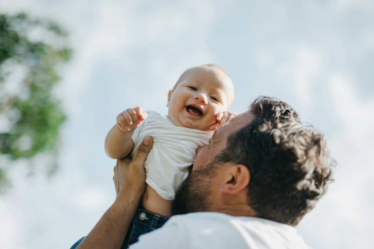 Dad kissing baby's tummy