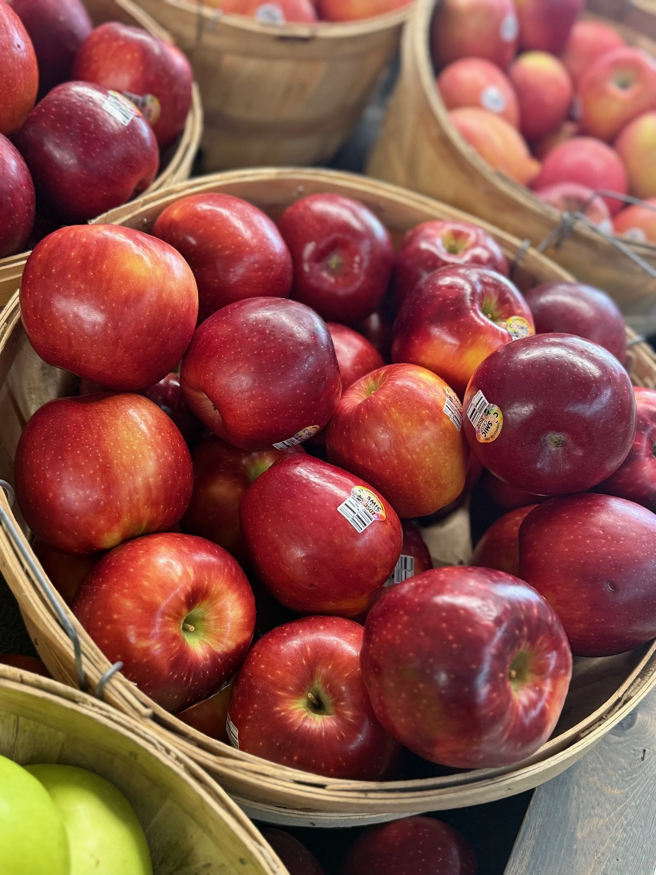 Basket of fresh red apples at a grocery store.