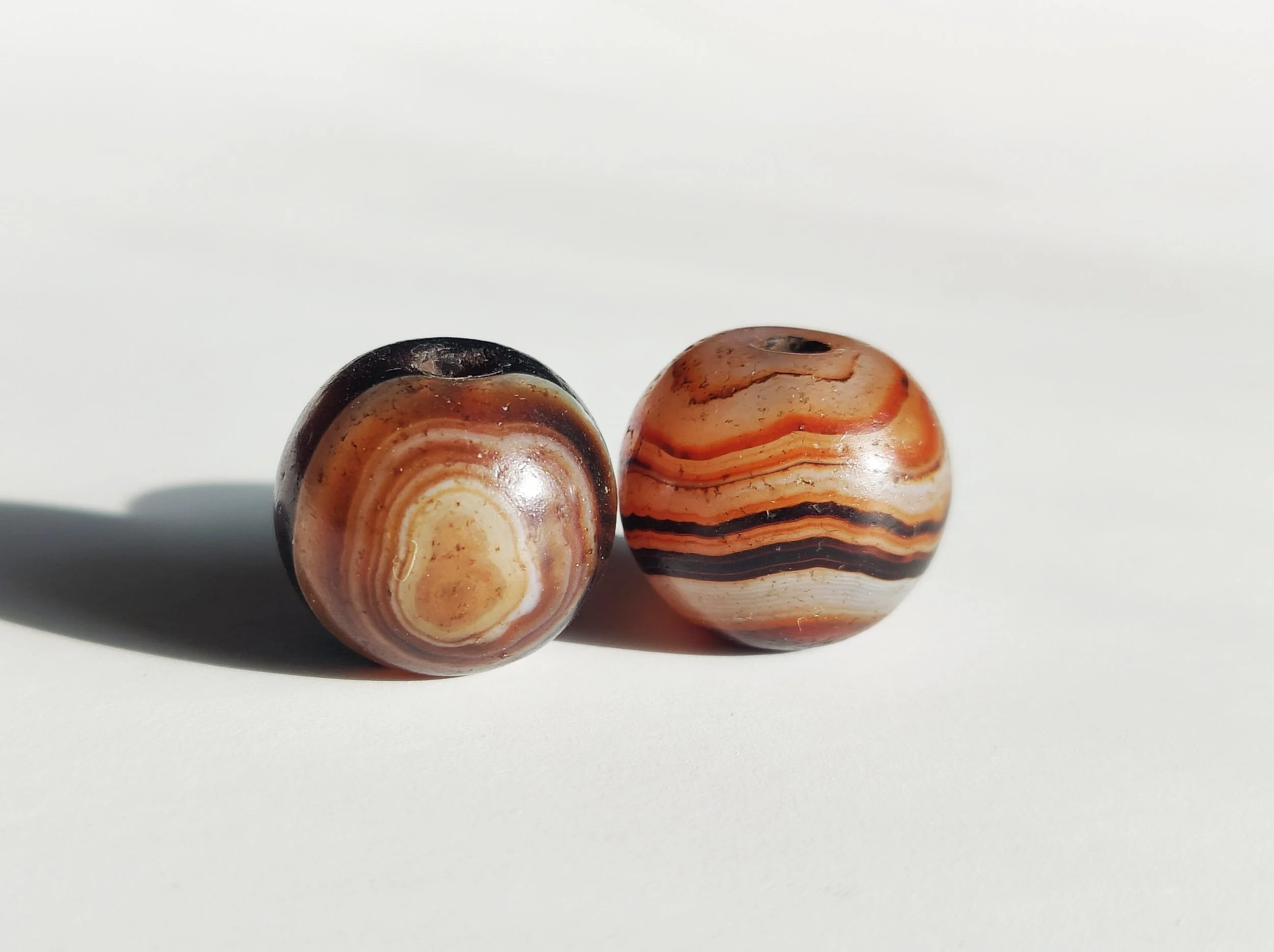 A Pair of Tibetan Round Dzi Beads in Banded Agate – Himalayan Region