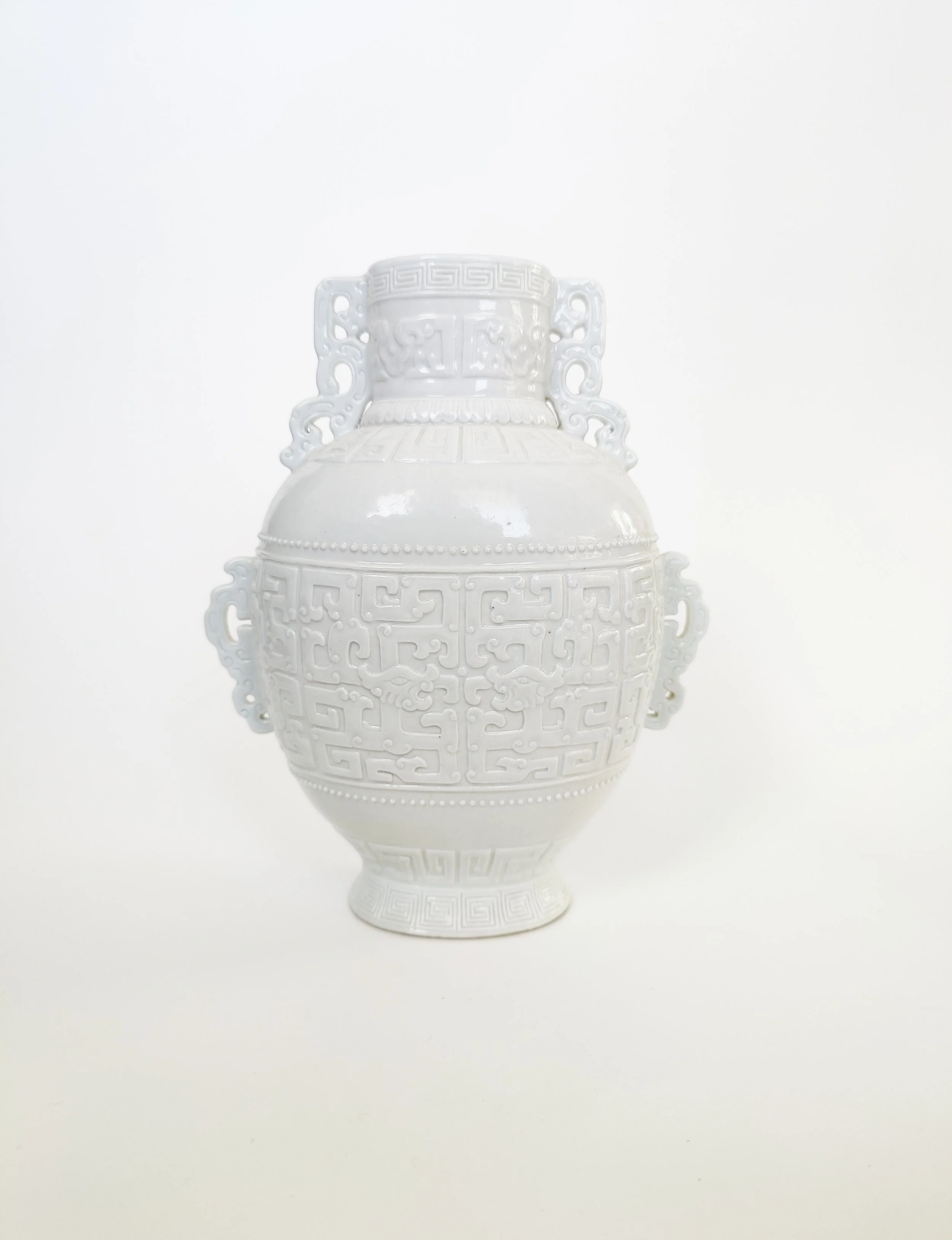A Chinese Monochrome White-Glazed Porcelain Vase with Archaic Dragon Motif and Incised Mark