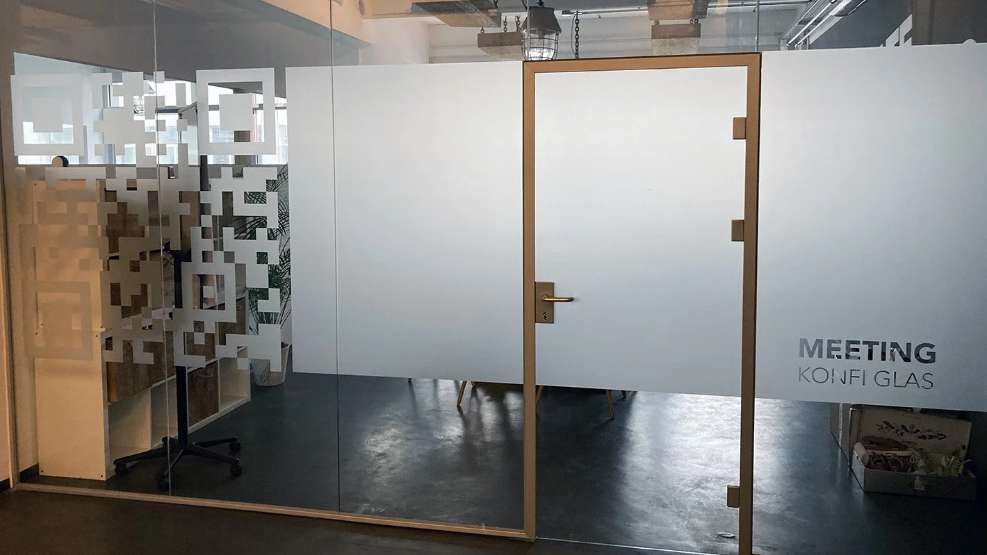 Blick auf eine Glaswand eines Besprechungszimmer. Foliert mit Milchglas.