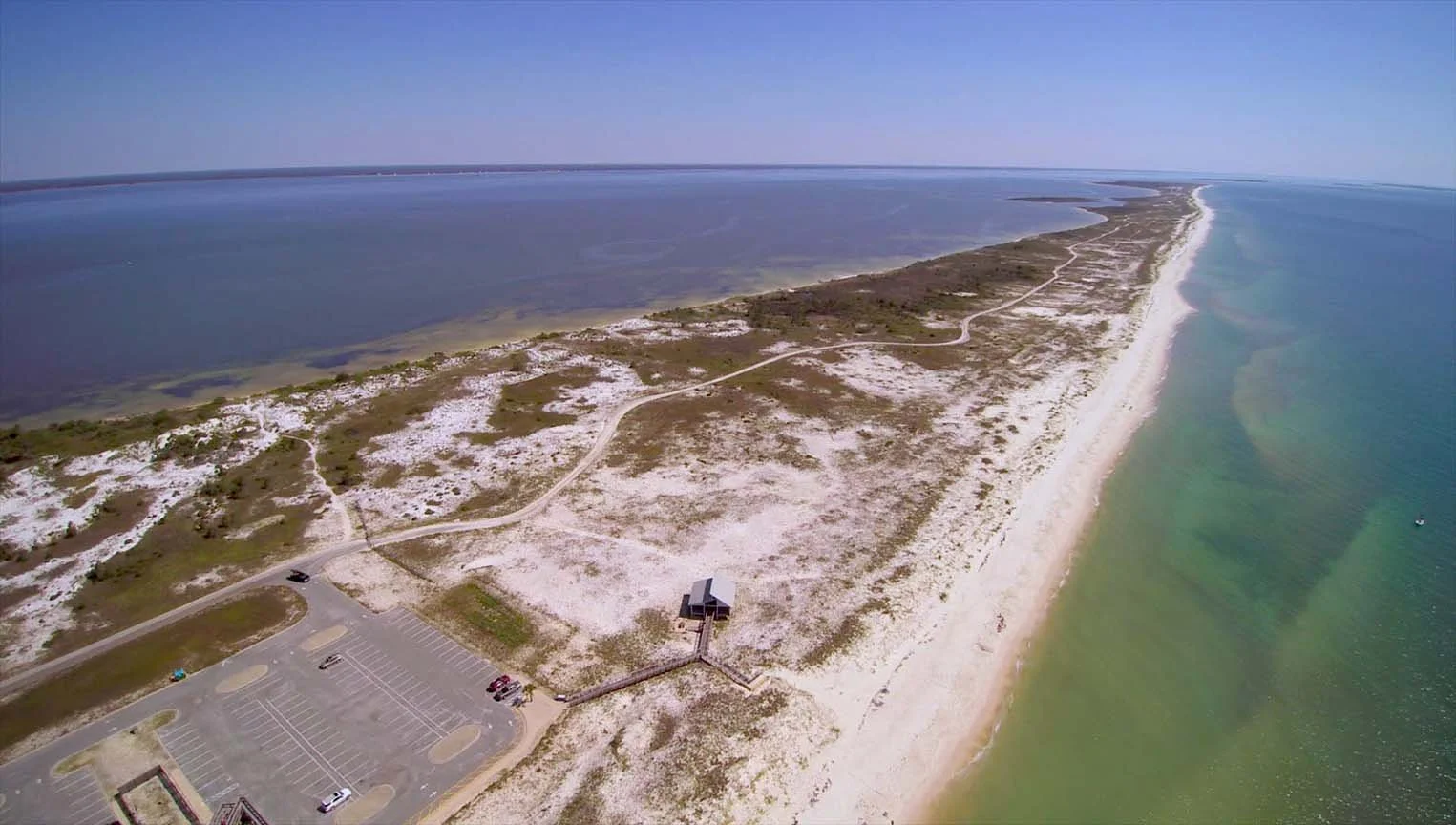 White sand beach stretching out into the ocean in Florida's Apalachicola Biosphere Region.