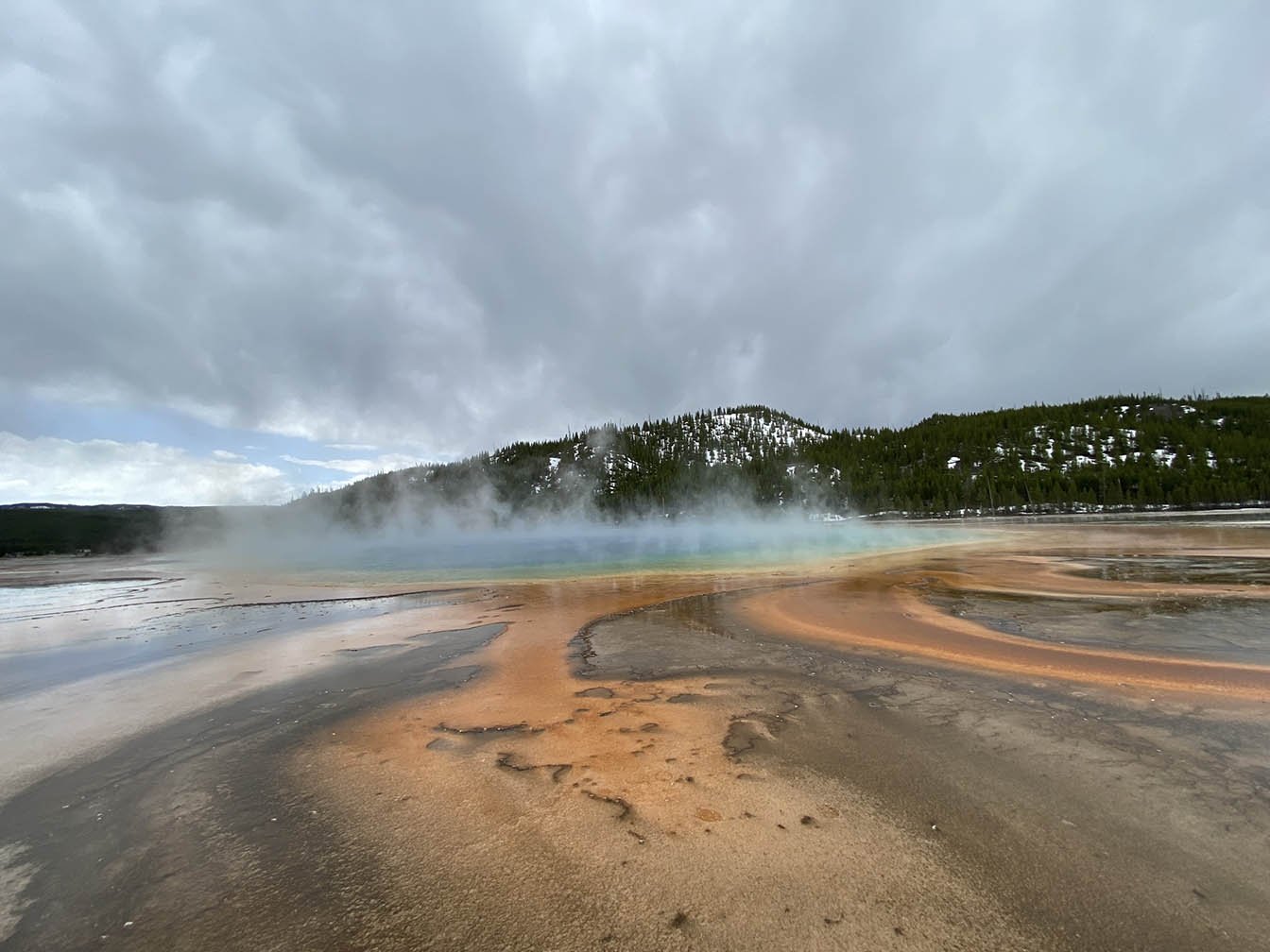 Steam rising from a multi-colored spring with snow covered trees in the background in the Yellowstone-Grand Teton Biosphere Region. (Copy) (Copy) (Copy)