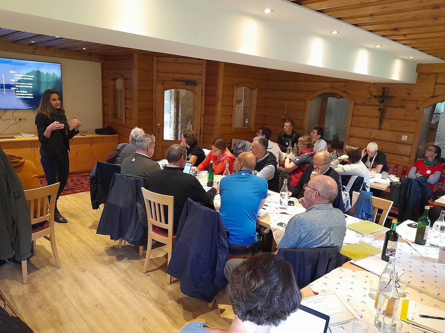 usbn facilitating a meeting with multiple tables full of participants