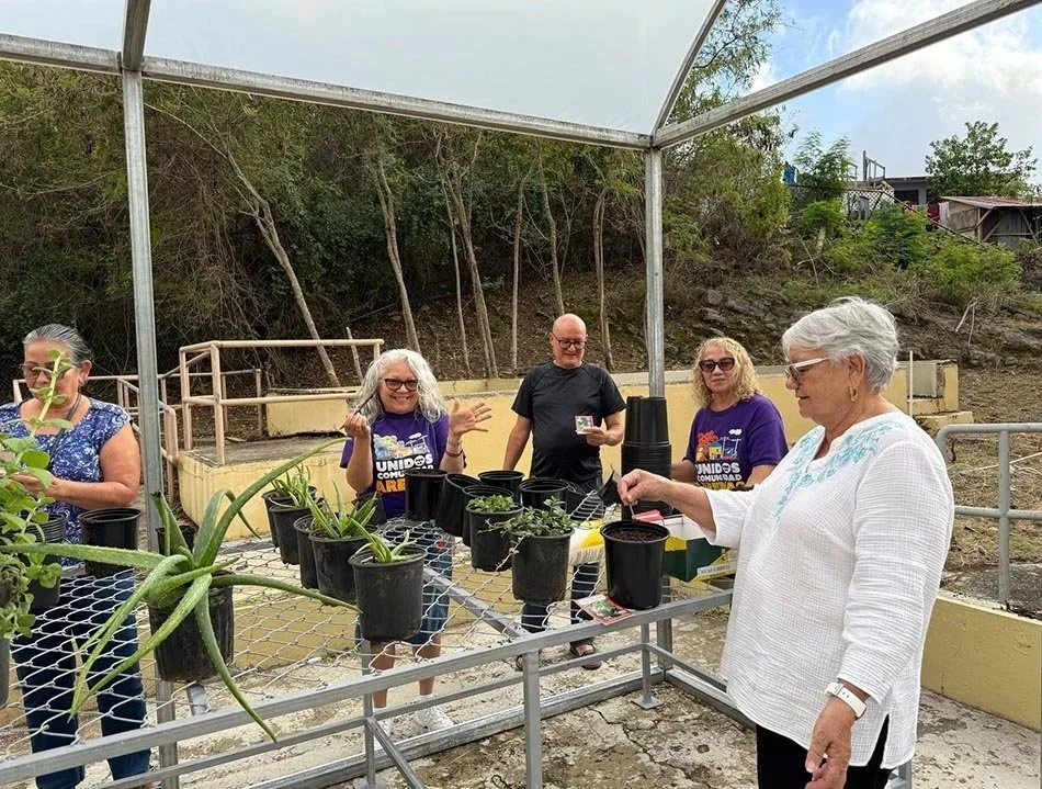 Group of people potting plants together in Puerto Rico's Guanica Biosphere Region.