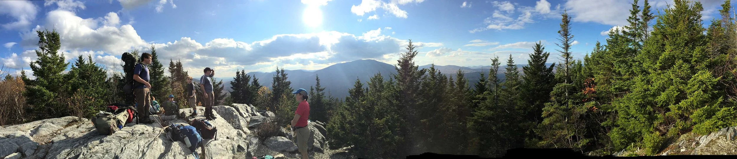 group-of-backpackers-looking-out-over-the-mountains-of-the-champlainadirondack-biosphere-network