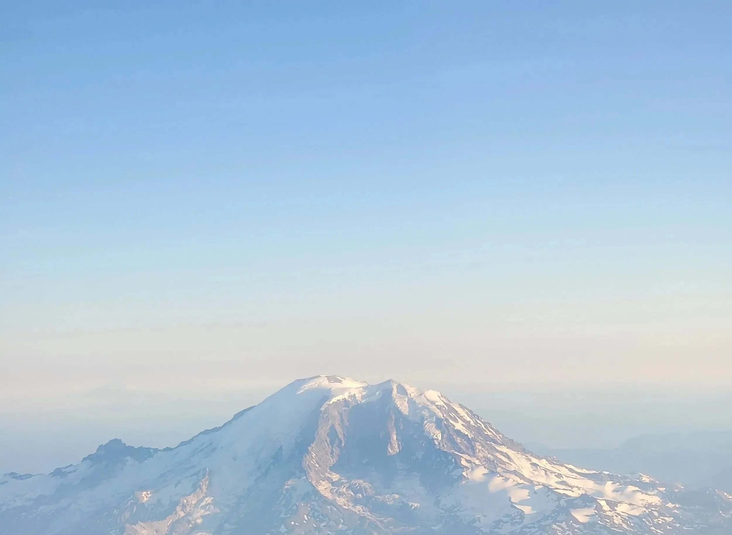 Snow-capped mountain peak under a clear blue sky.