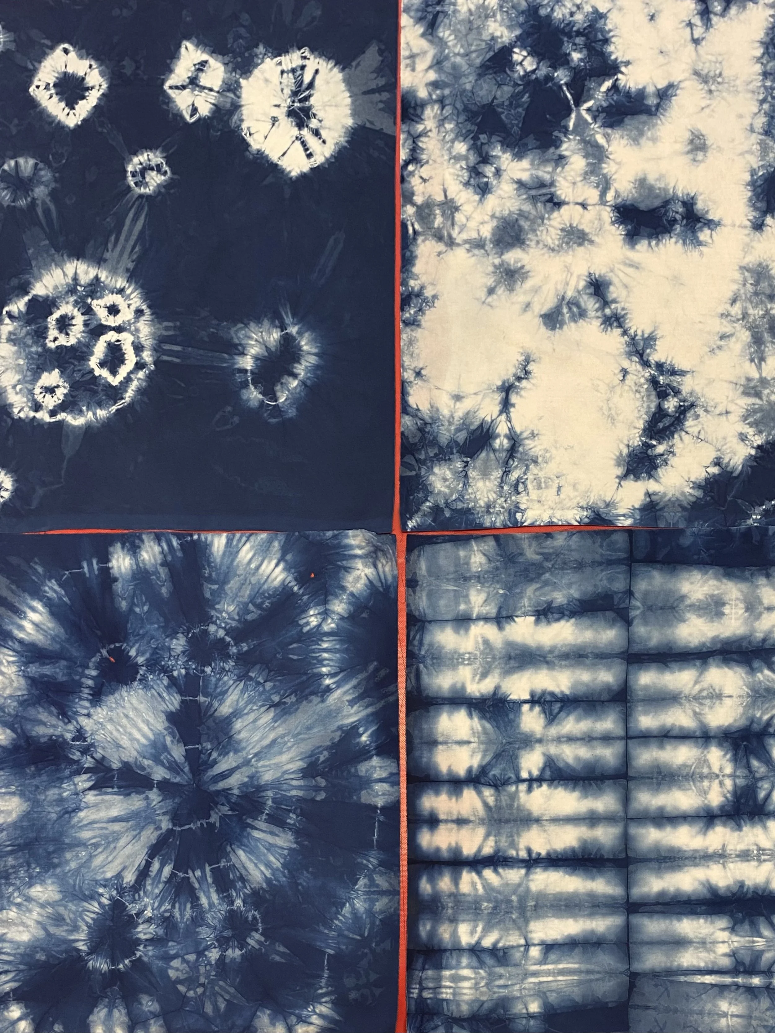 Four pieces of fabric with blue and white tie-dye patterns, each with distinct designs, arranged in a grid with red borders.