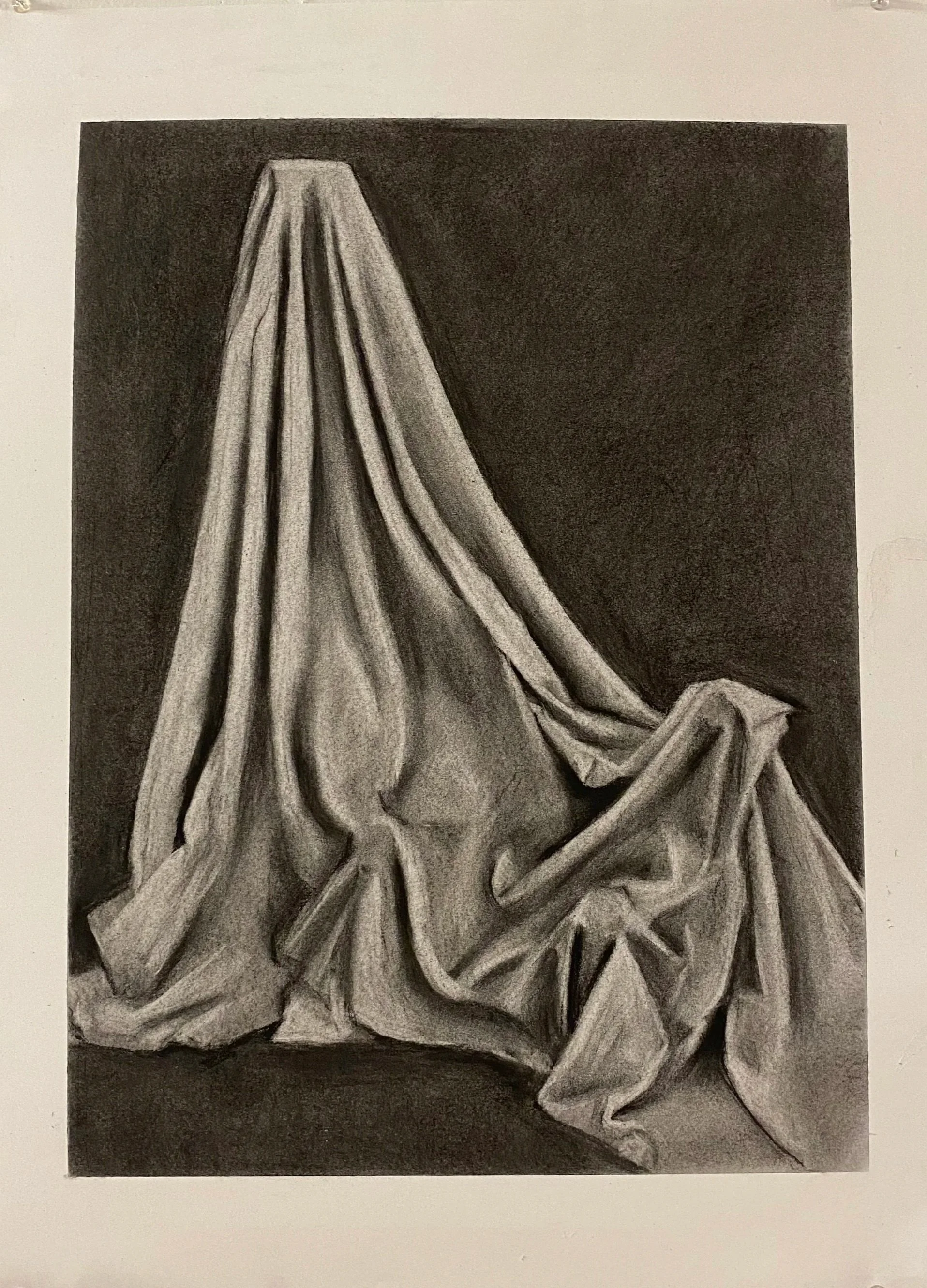 A black and white drawing of a crumpled cloth or fabric with folds and creases, set against a dark background.