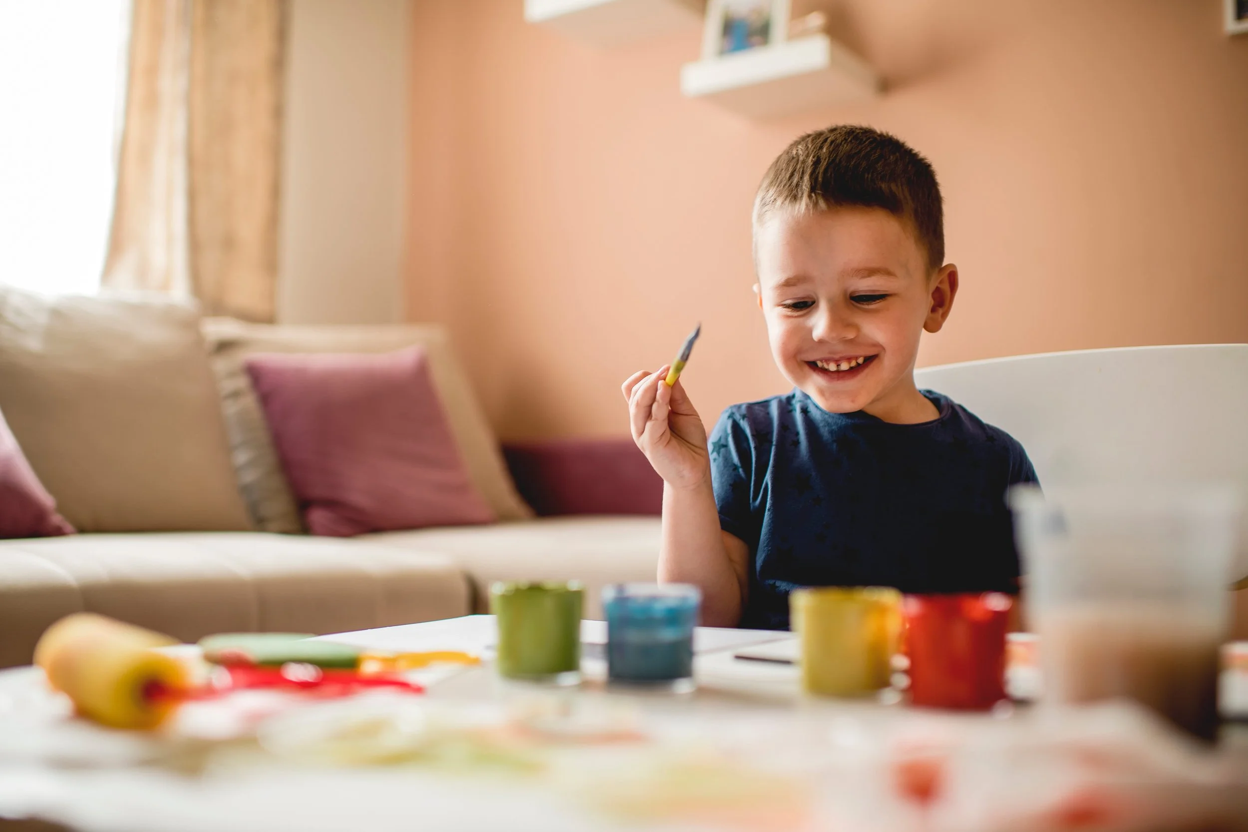 boy painting during aba therapy using ESDM and NDBI