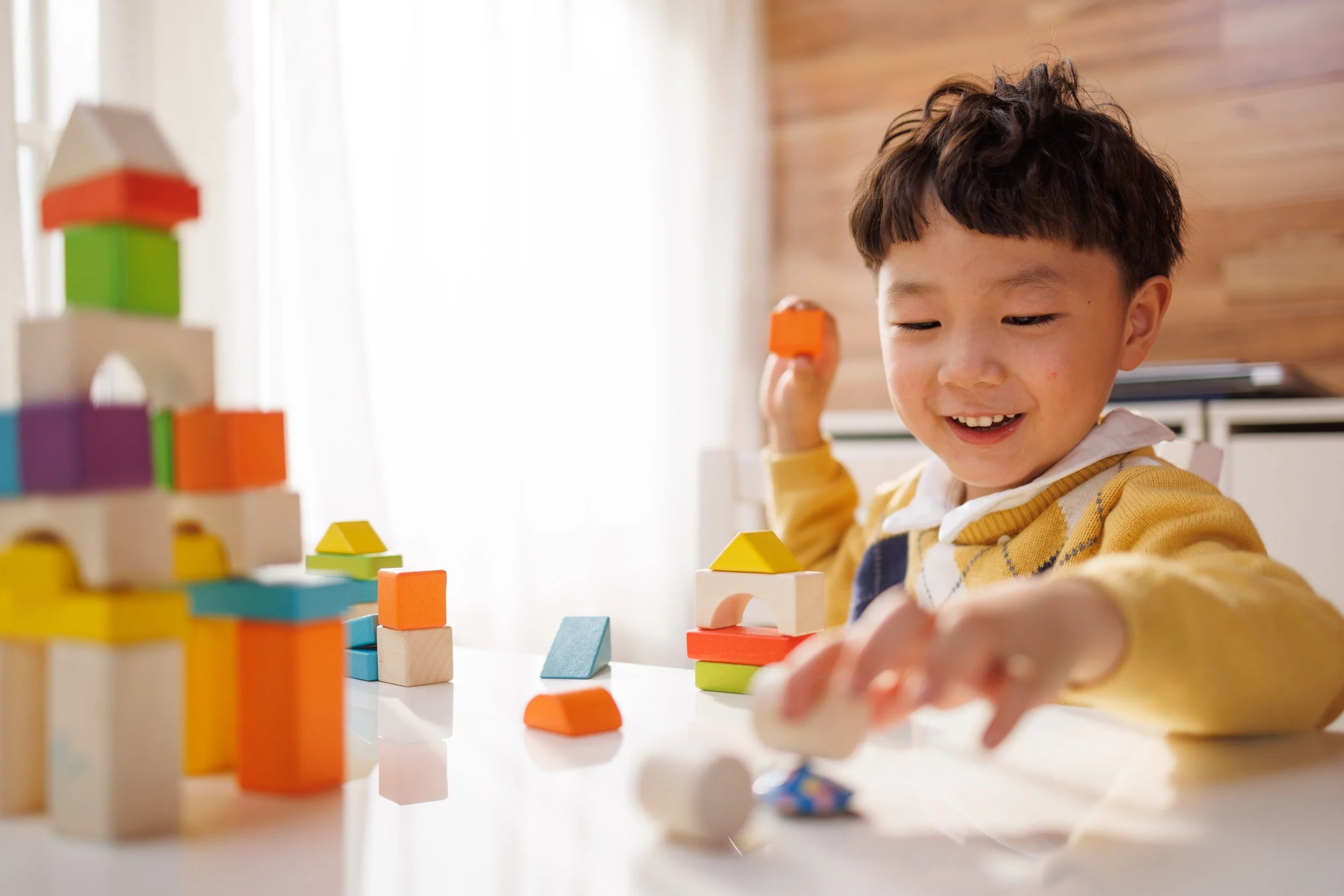 boy playing with blocks during aba therapy using ESDM and NDBI