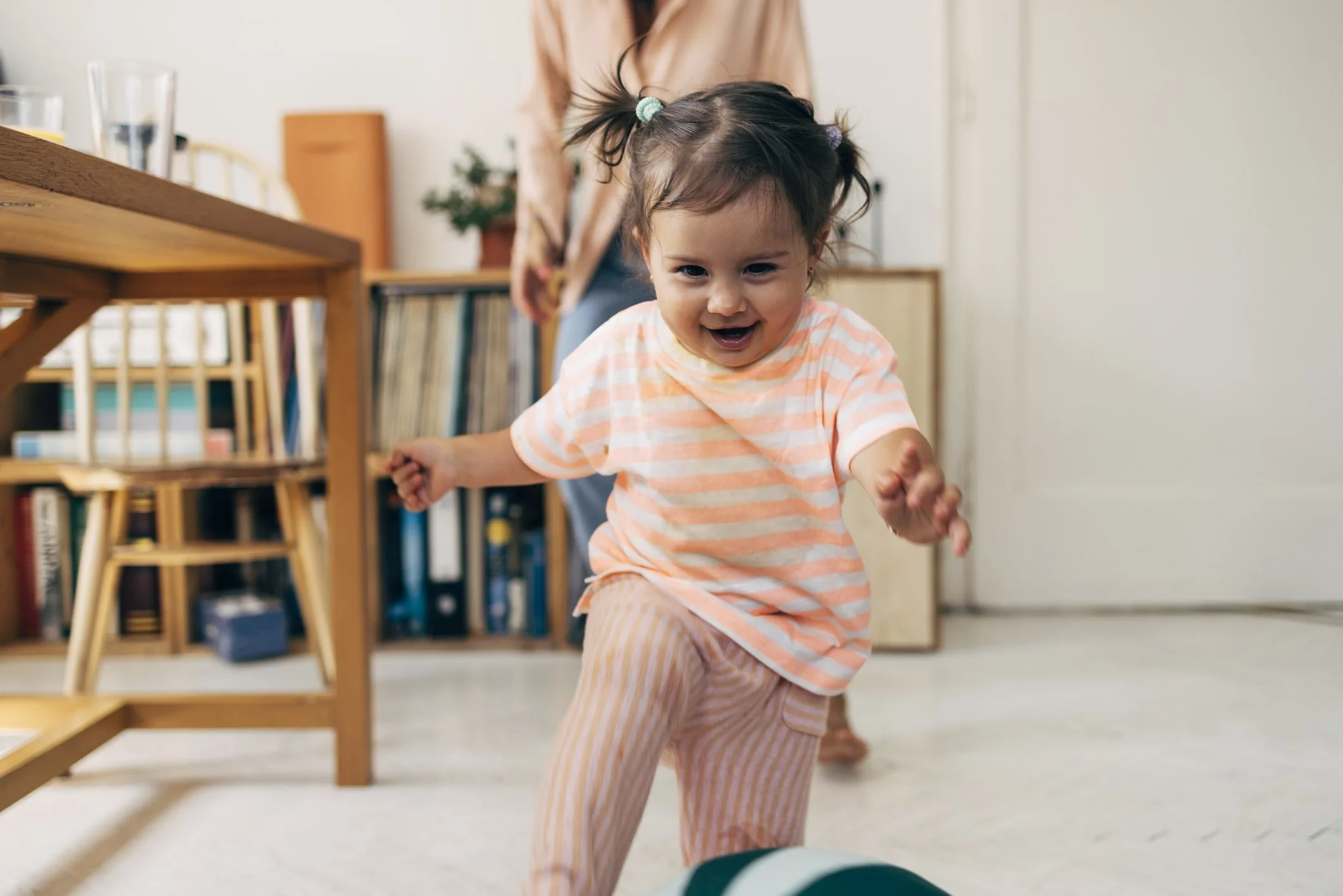 Little girl smiling and running playing during ABA therapy using ESDM and NDBI
