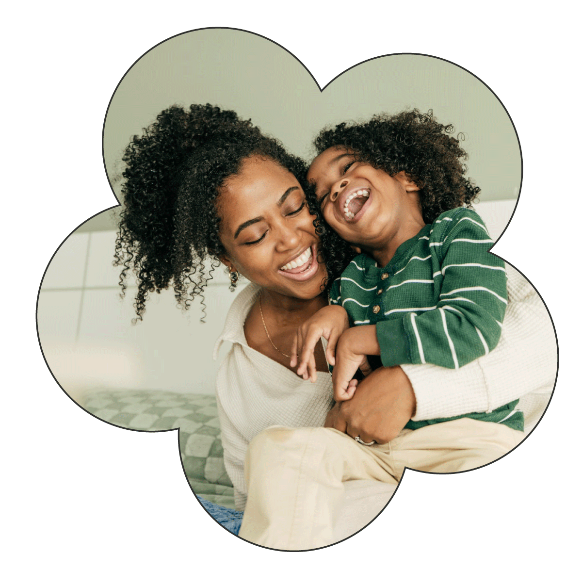 Mother and son smiling and laughing hugging