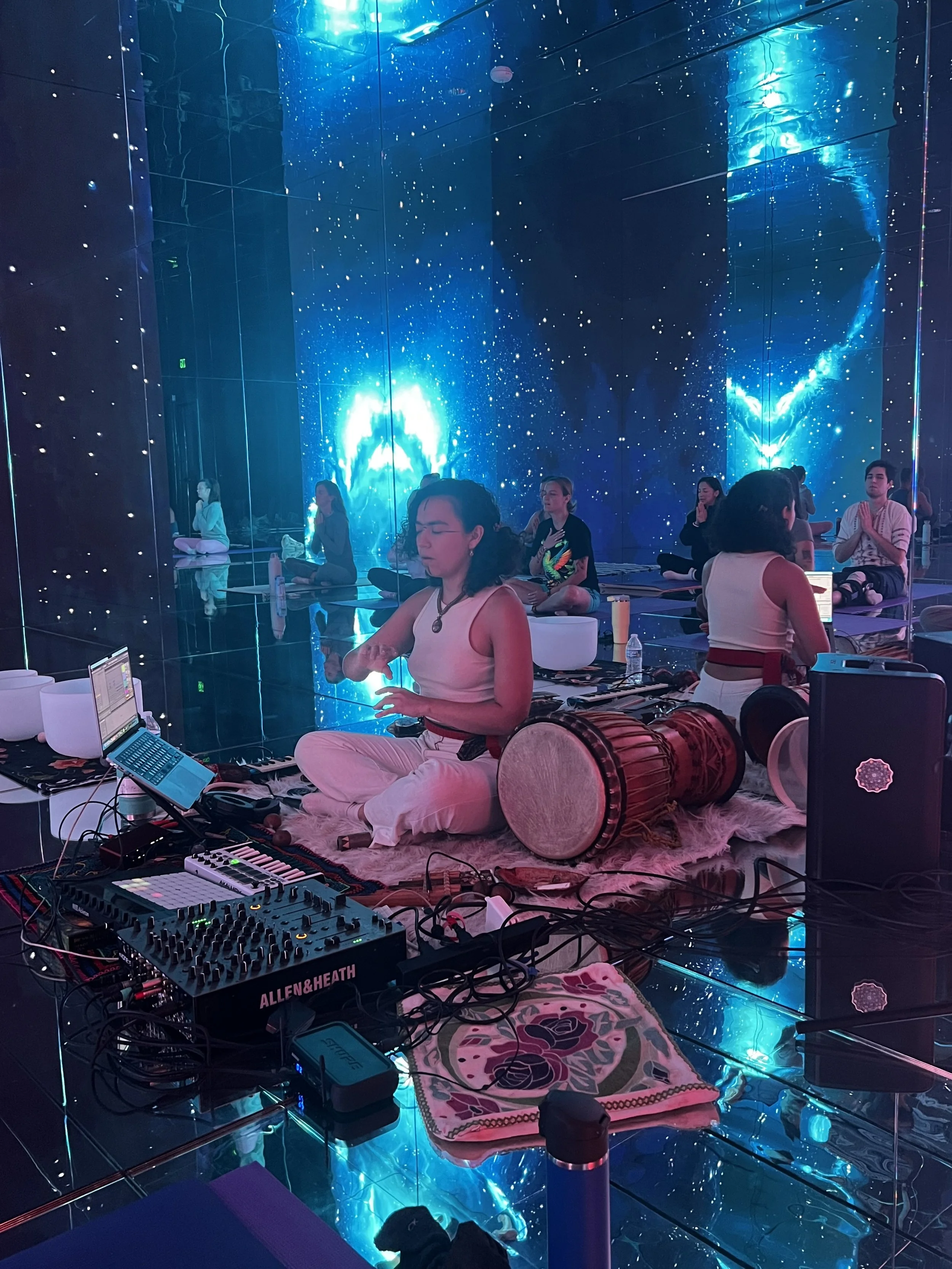 Delady DJ performing live music production set with tribal rhythms and electronic soundscapes.