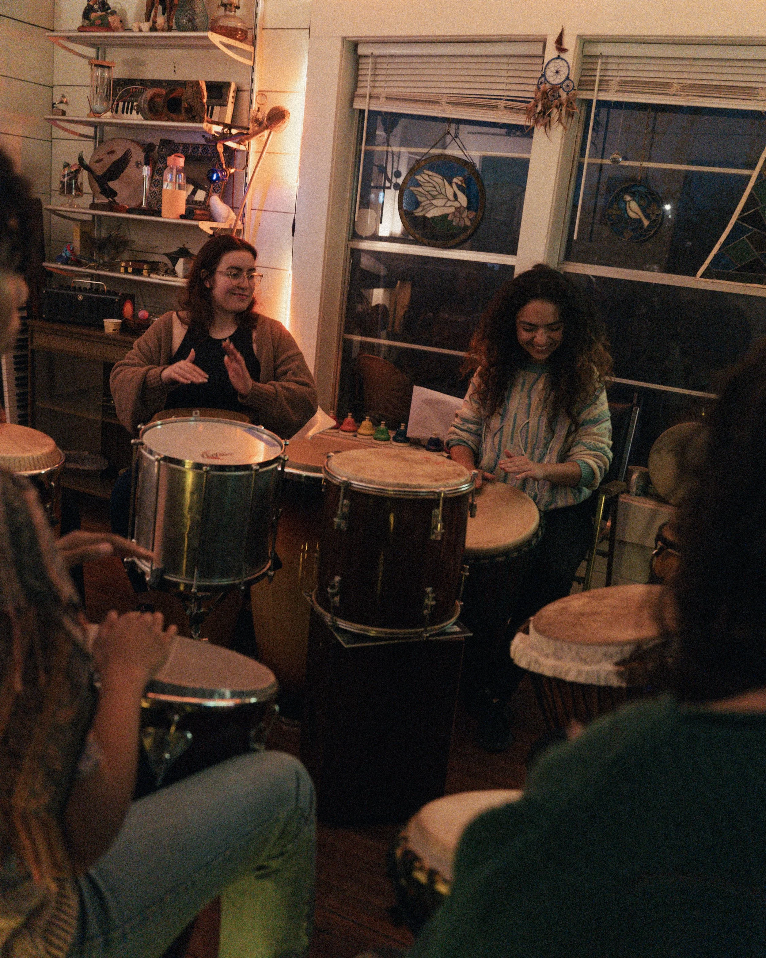 Group drum circle during immersive music creation retreat at Lost Forest Cabins Richard Texas.