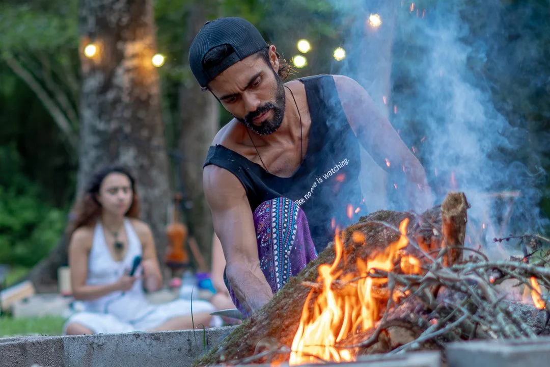 Participants connecting around campfire at immersive music creation retreat in Lost Forest Cabins Texas.