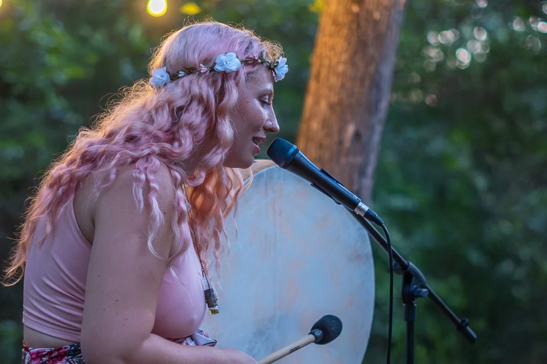 The Love Faery leading voice activation ceremony at outdoor music creation retreat in Texas.