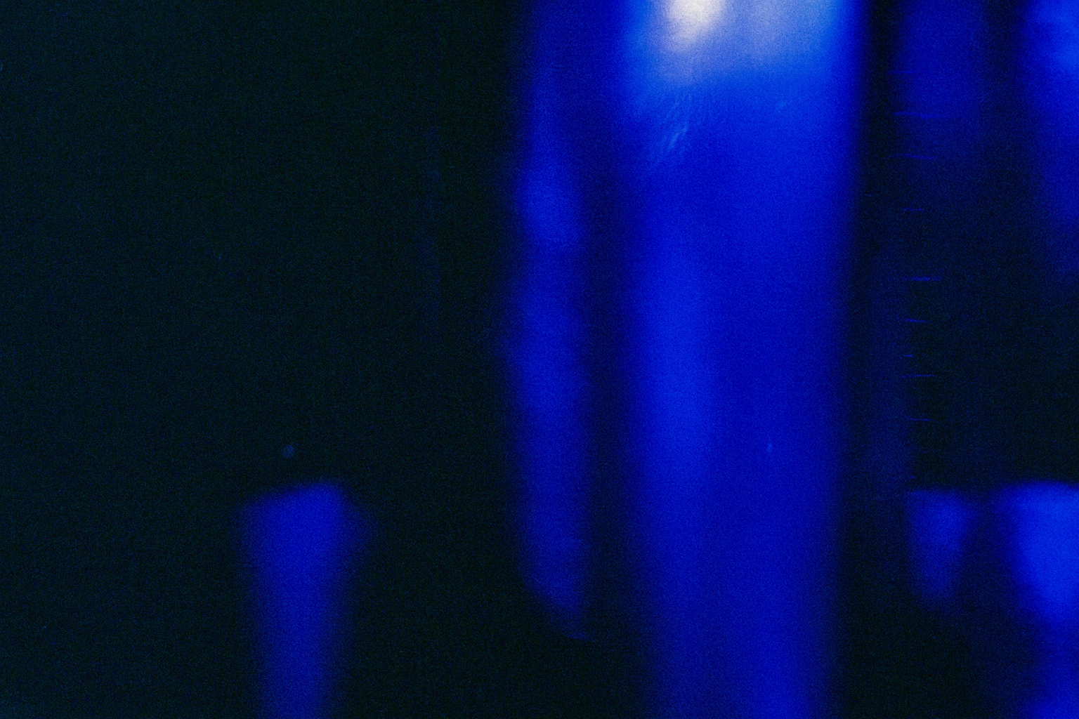 Dark background with vertical blue light streaks