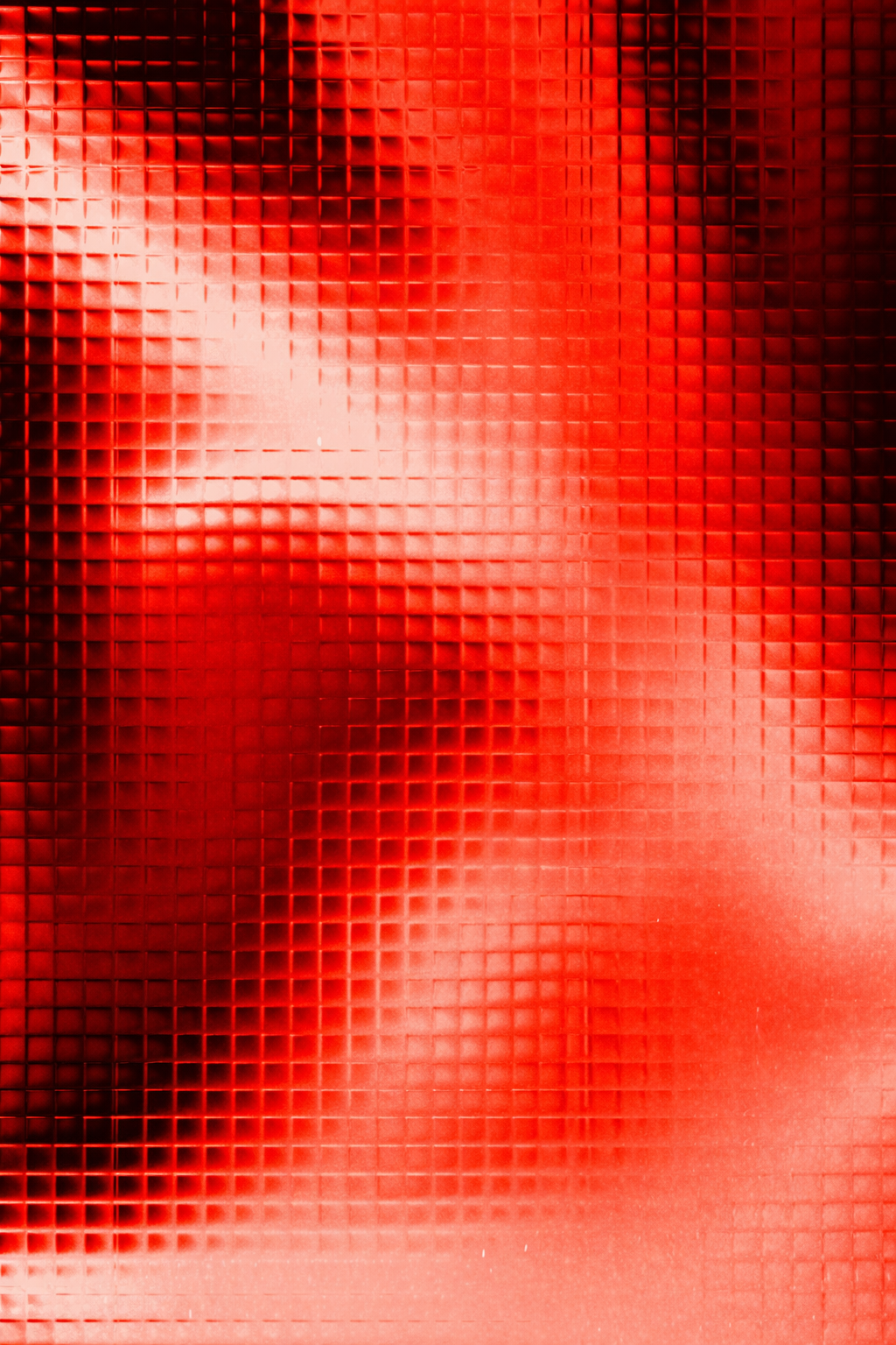 Abstract image of a textured red glass surface with light reflections